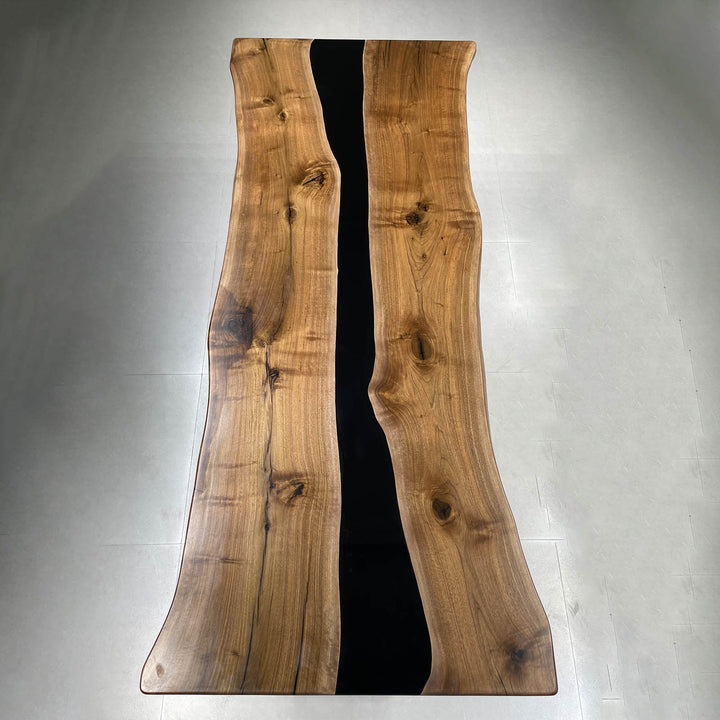 Solid hardwood live edge table with deep black epoxy center channel