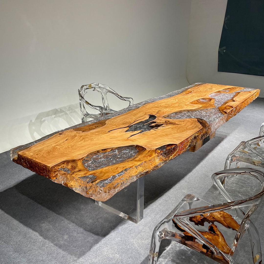 Olive wood and resin table with transparent chairs, showcasing a unique blend of natural and modern elements