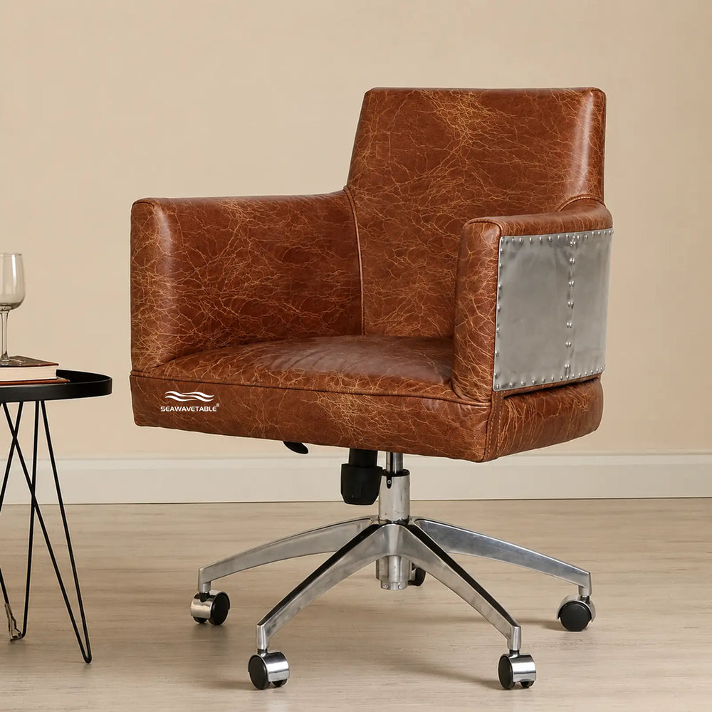Upholstered office chair with textured leather finish and silver metal armrest panel