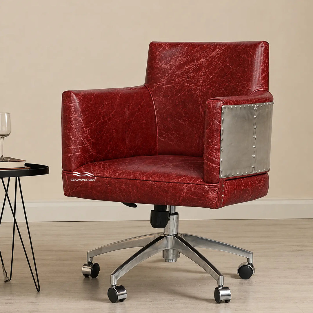 Industrial office chair featuring brown leather upholstery and decorative metal rivets