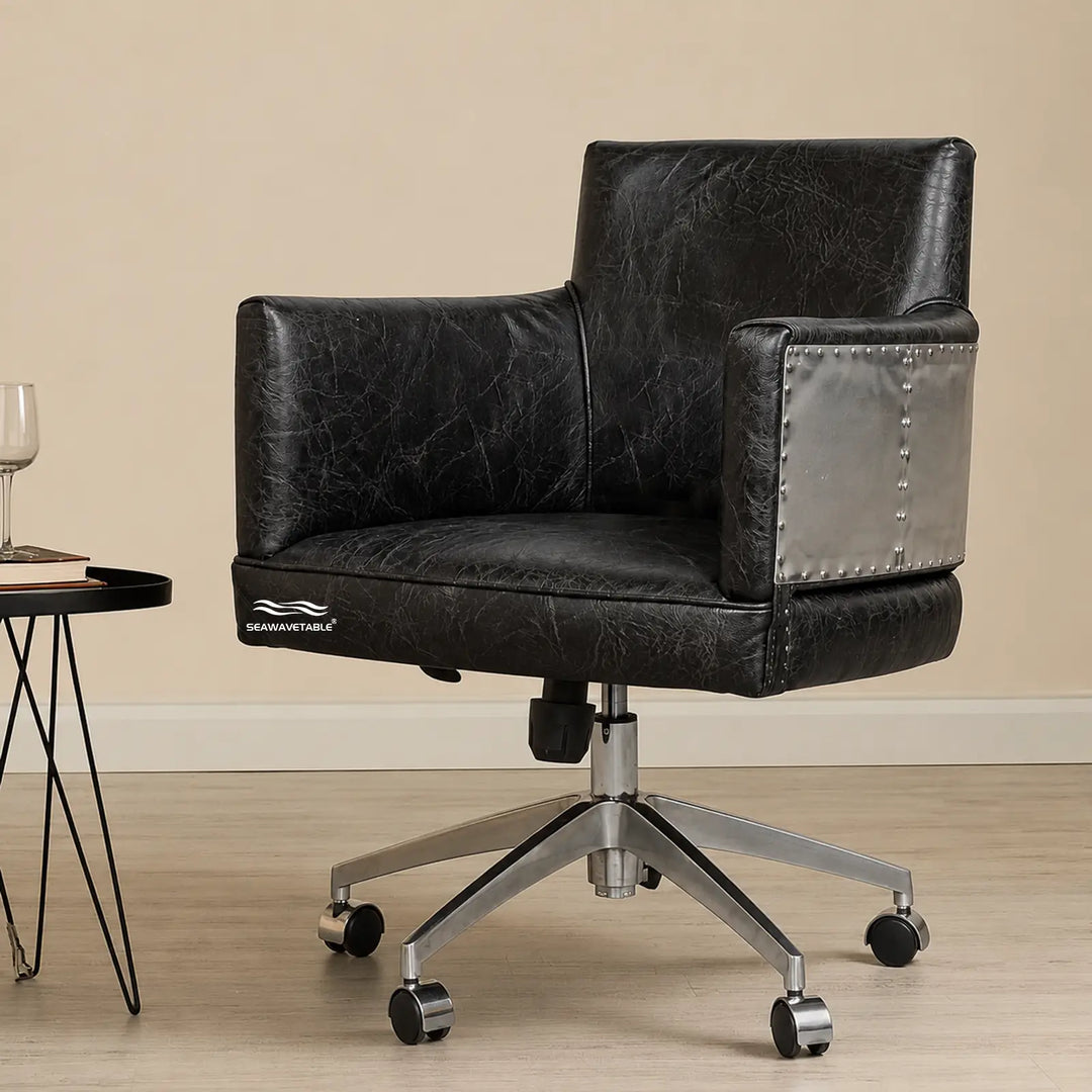 Leather executive desk chair with silver metal armrest accent and smooth-rolling wheels