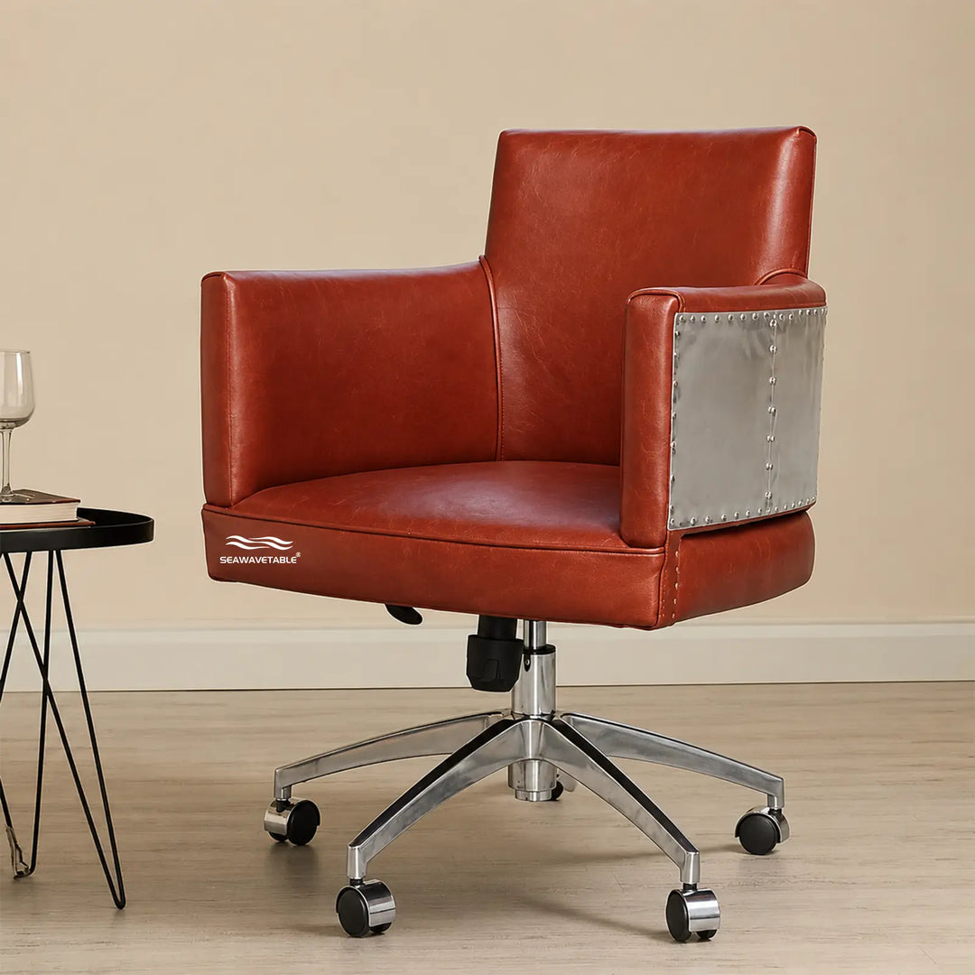 Vintage leather office chair with polished metal base and riveted armrest detail