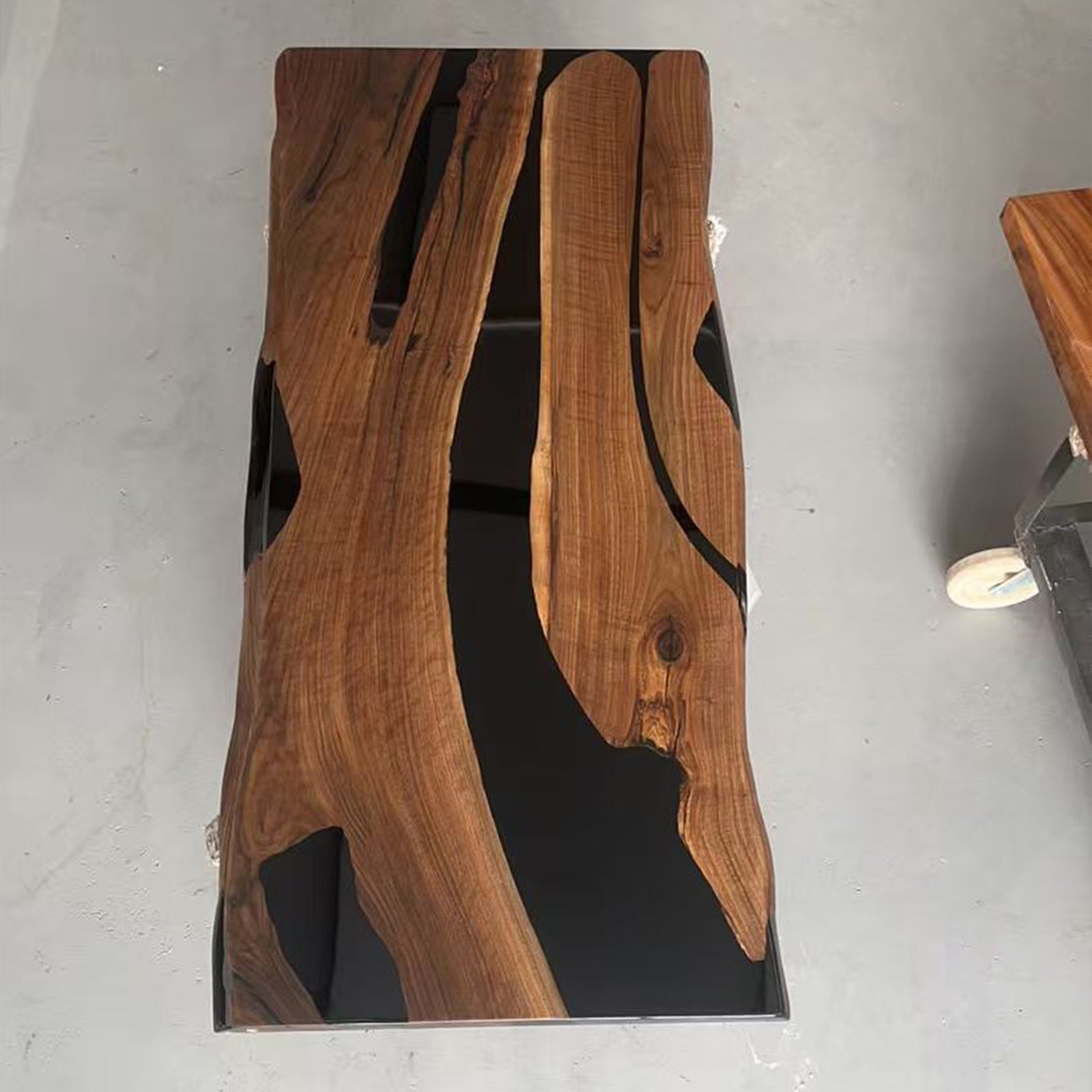 Luxury solid wood dining table crafted from black walnut with a striking black epoxy river