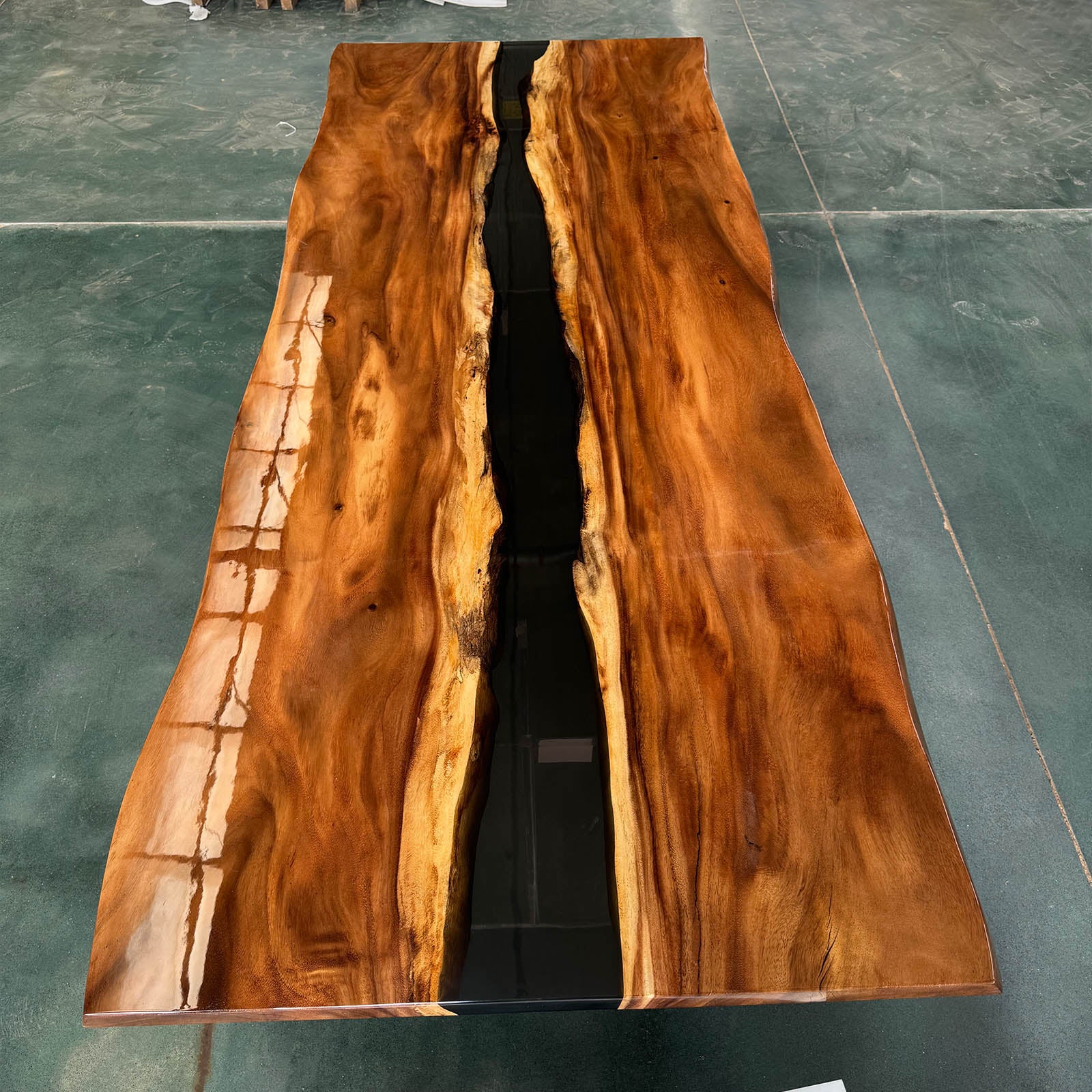 Professional corporate office featuring a rectangular black walnut meeting table with black epoxy river