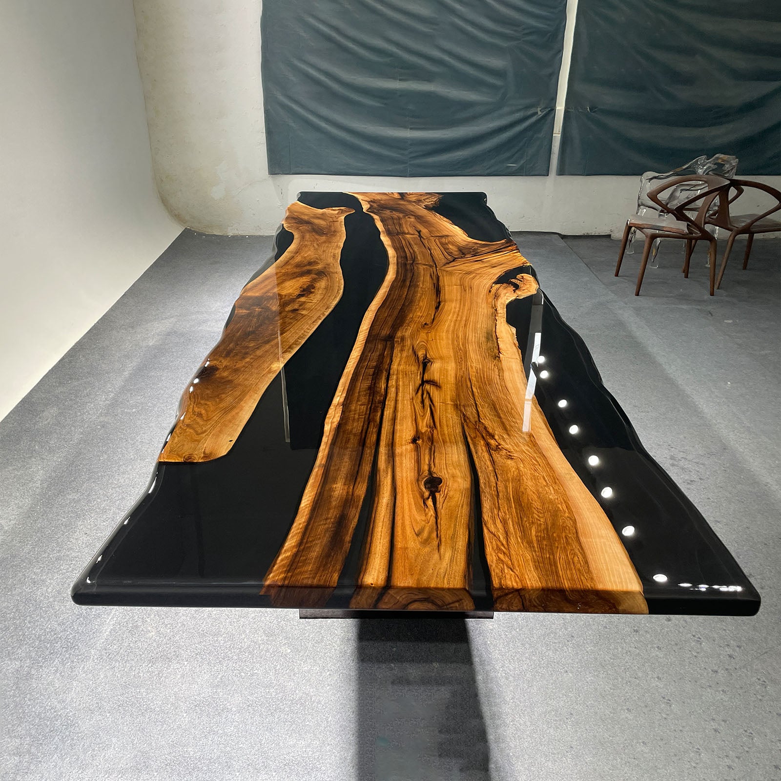 Close-up showing resin fill details inside natural black walnut cavities with deep black epoxy