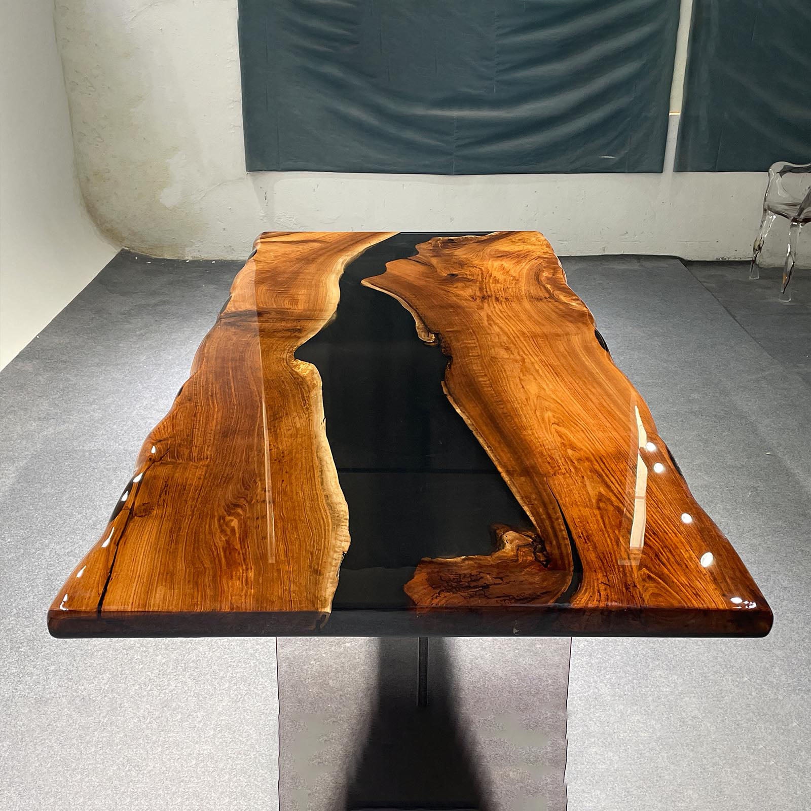 Close-up view showing detailed black walnut wood grain blending with glossy black epoxy river.