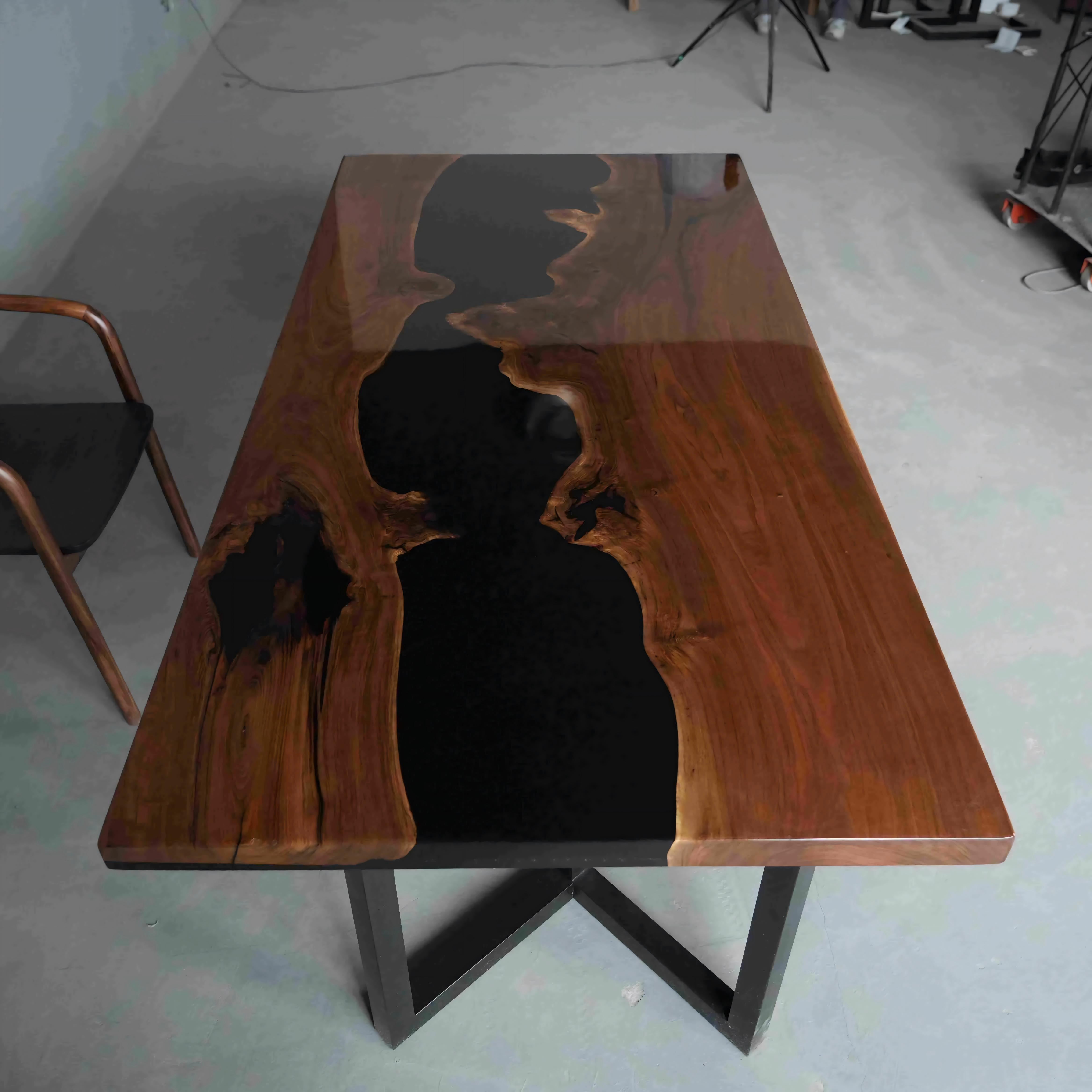 Handcrafted black walnut tabletop with contrasting white sapwood and premium black epoxy river.