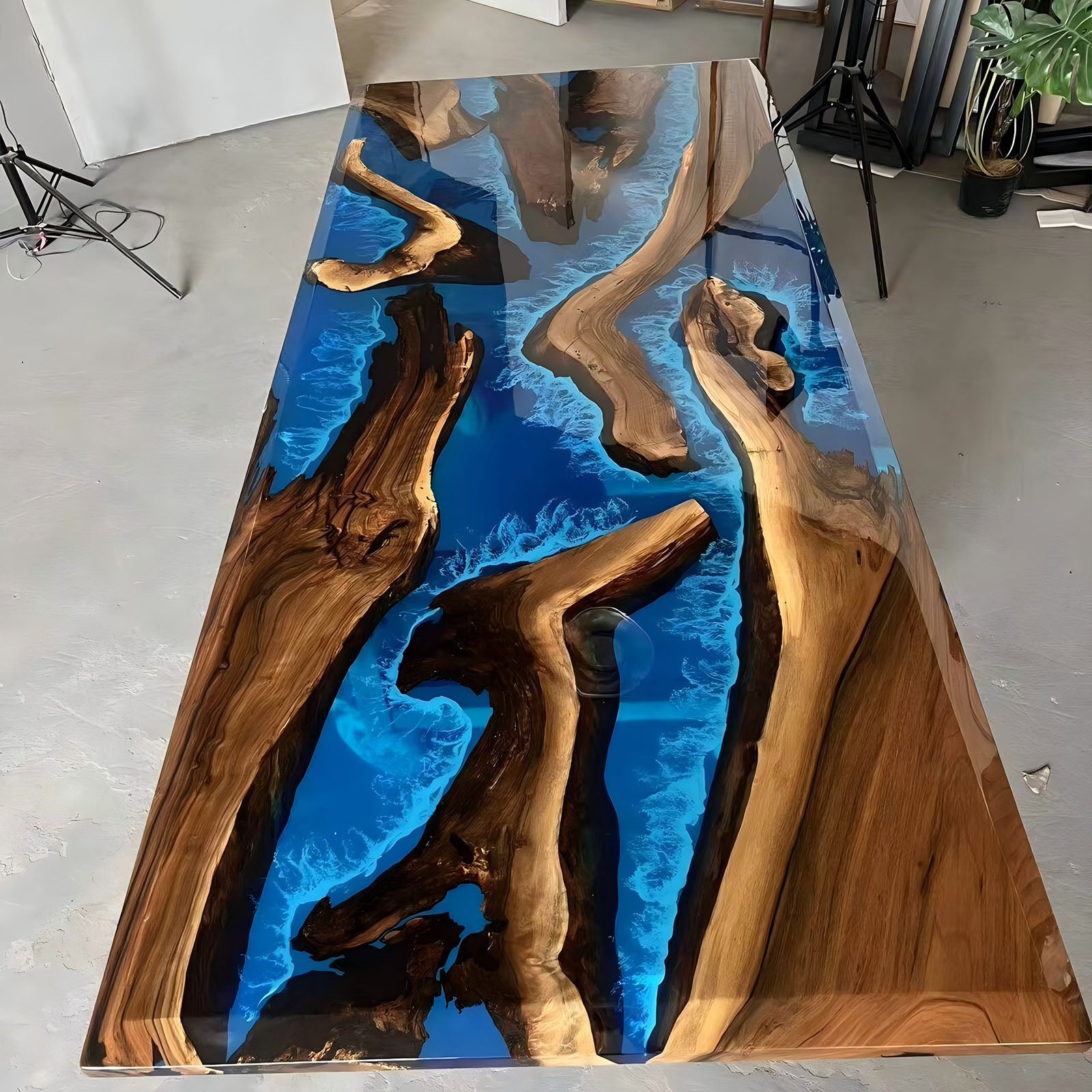 Finished black walnut dining table with deep blue transparent resin and white wave accents
