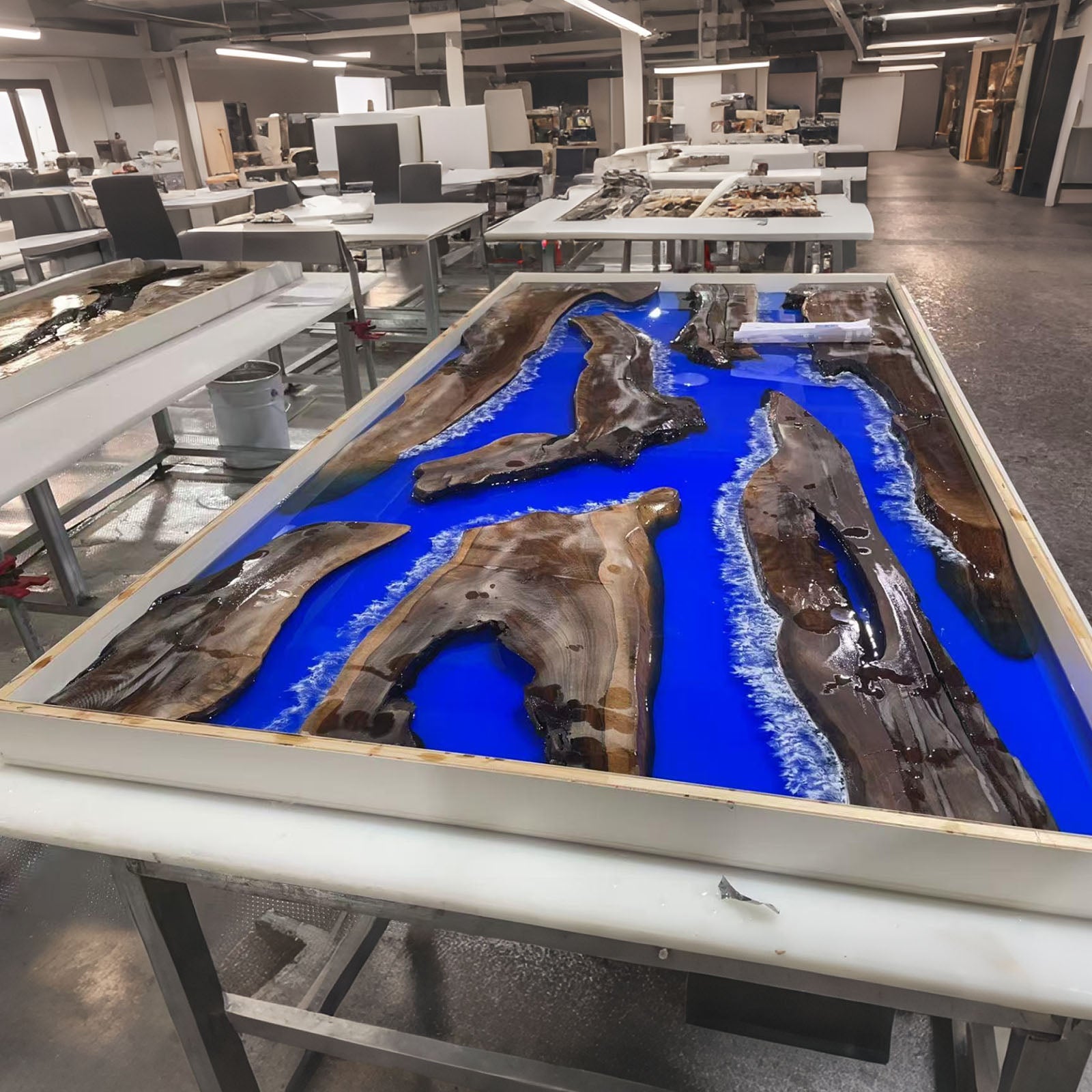 Another view of epoxy resin pouring for black walnut table with ocean-inspired design