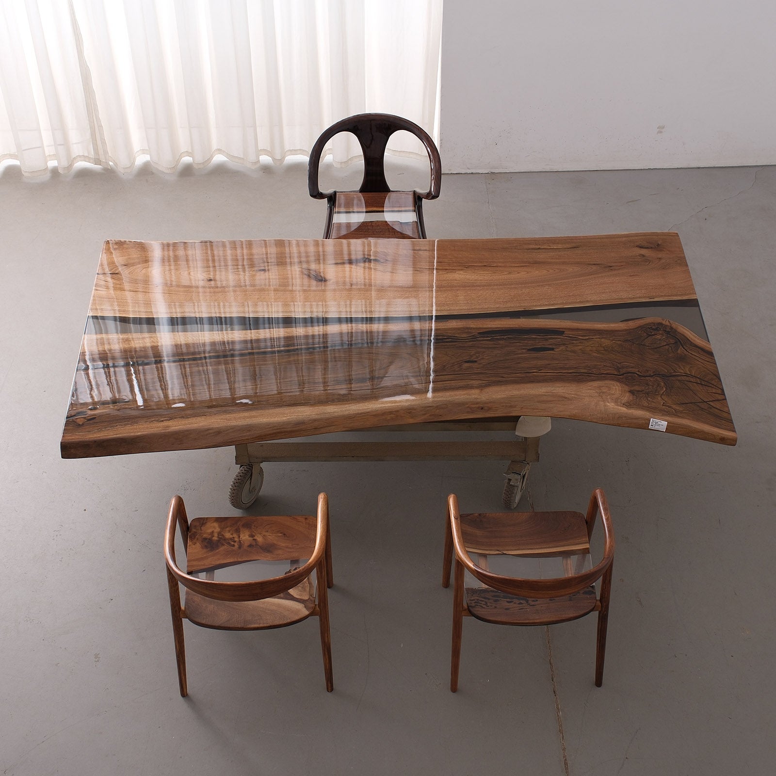 Boardroom setup featuring a large black walnut epoxy conference table with straight edges
