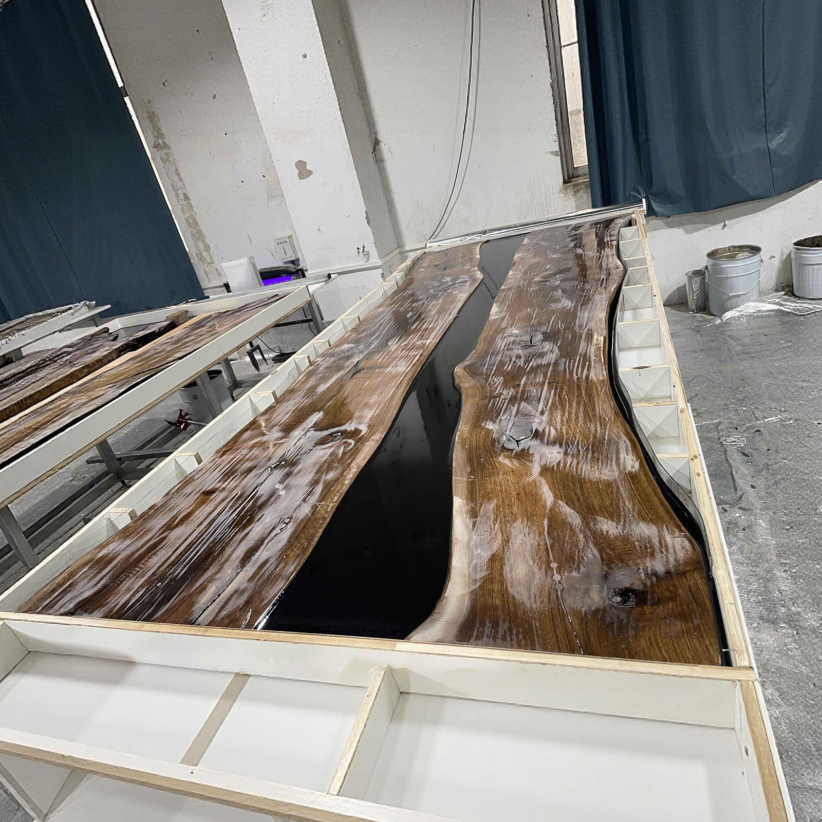 Minimalist luxury black walnut river table with smooth matte finish and dark epoxy flow.