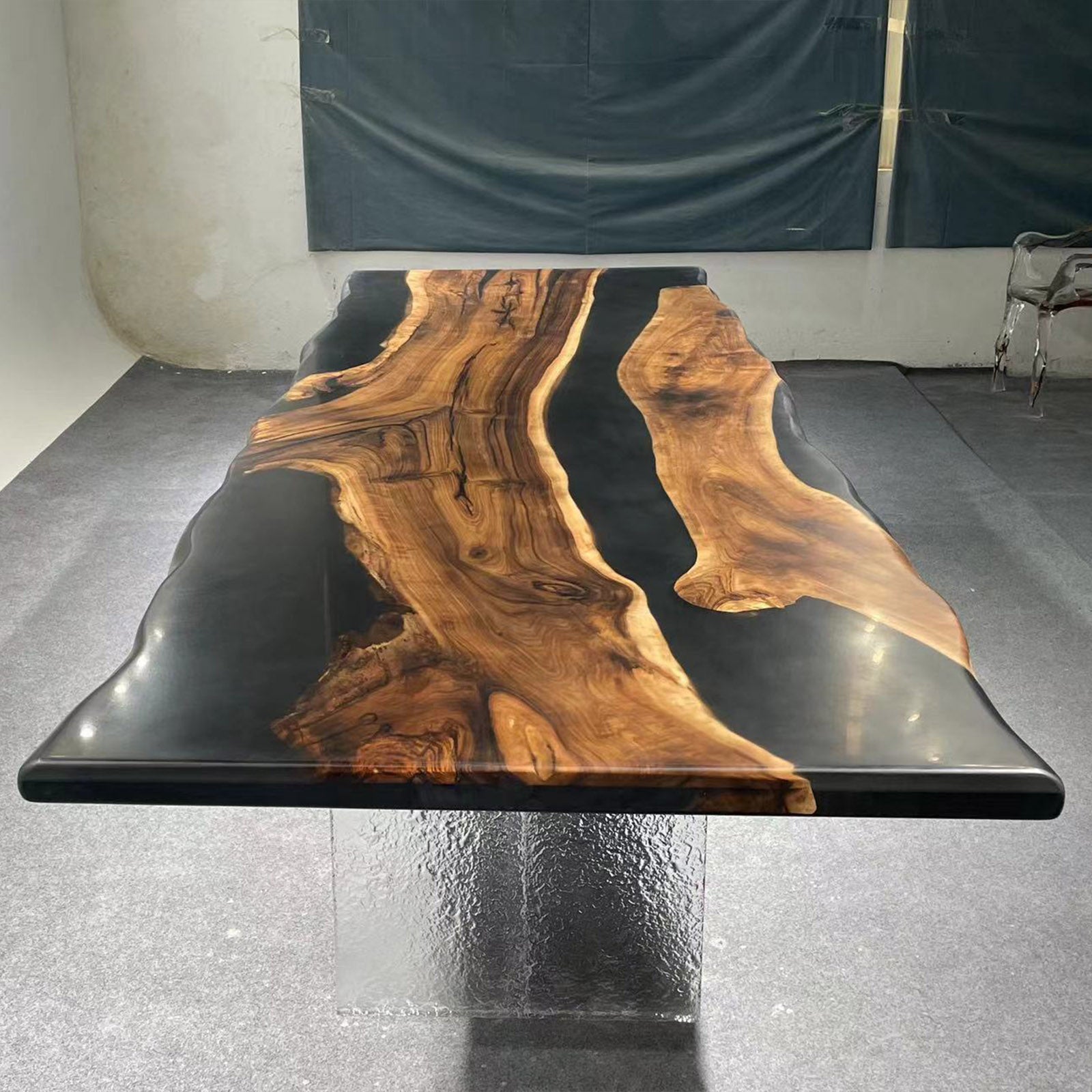 Top shot of dark black epoxy river embedded between two thick slabs of black walnut wood