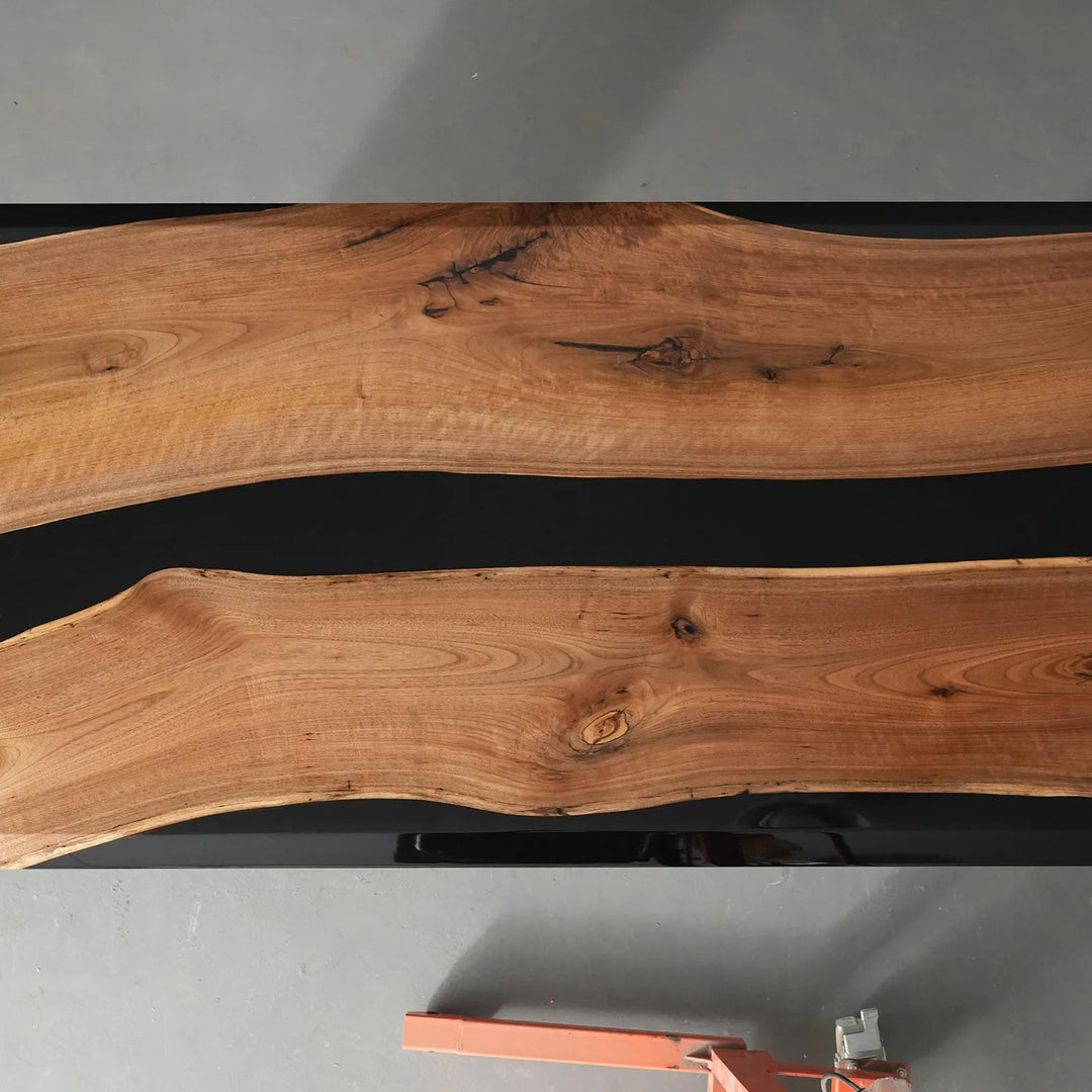 Black Walnut table with irregular black epoxy river design by SeawaveTable