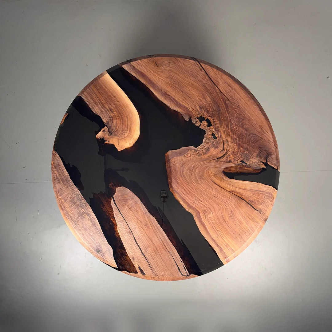 Round Black Walnut table with irregular transparent black epoxy design by SeawaveTable