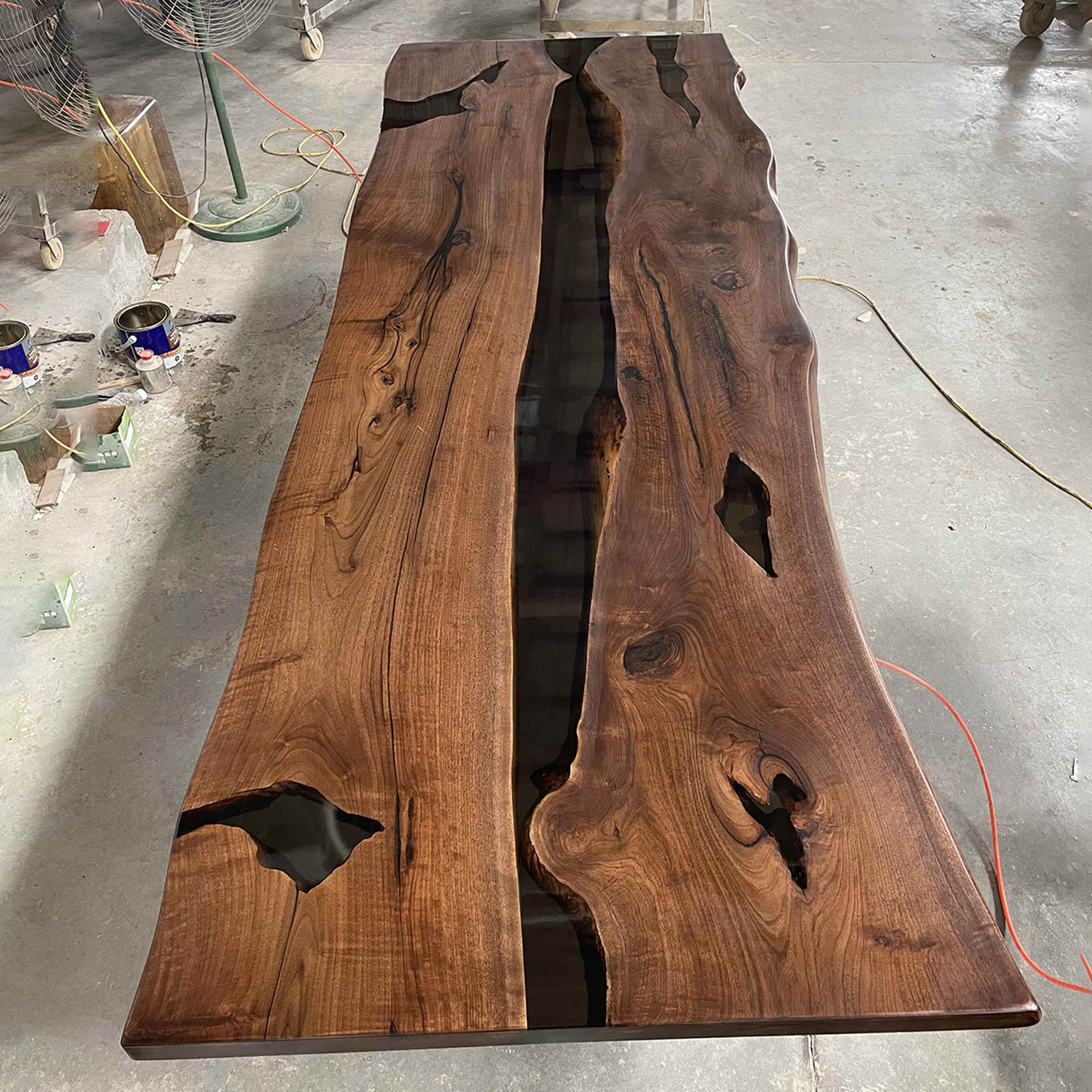 Handcrafted live edge black walnut dining table with rich grain and black epoxy contrast