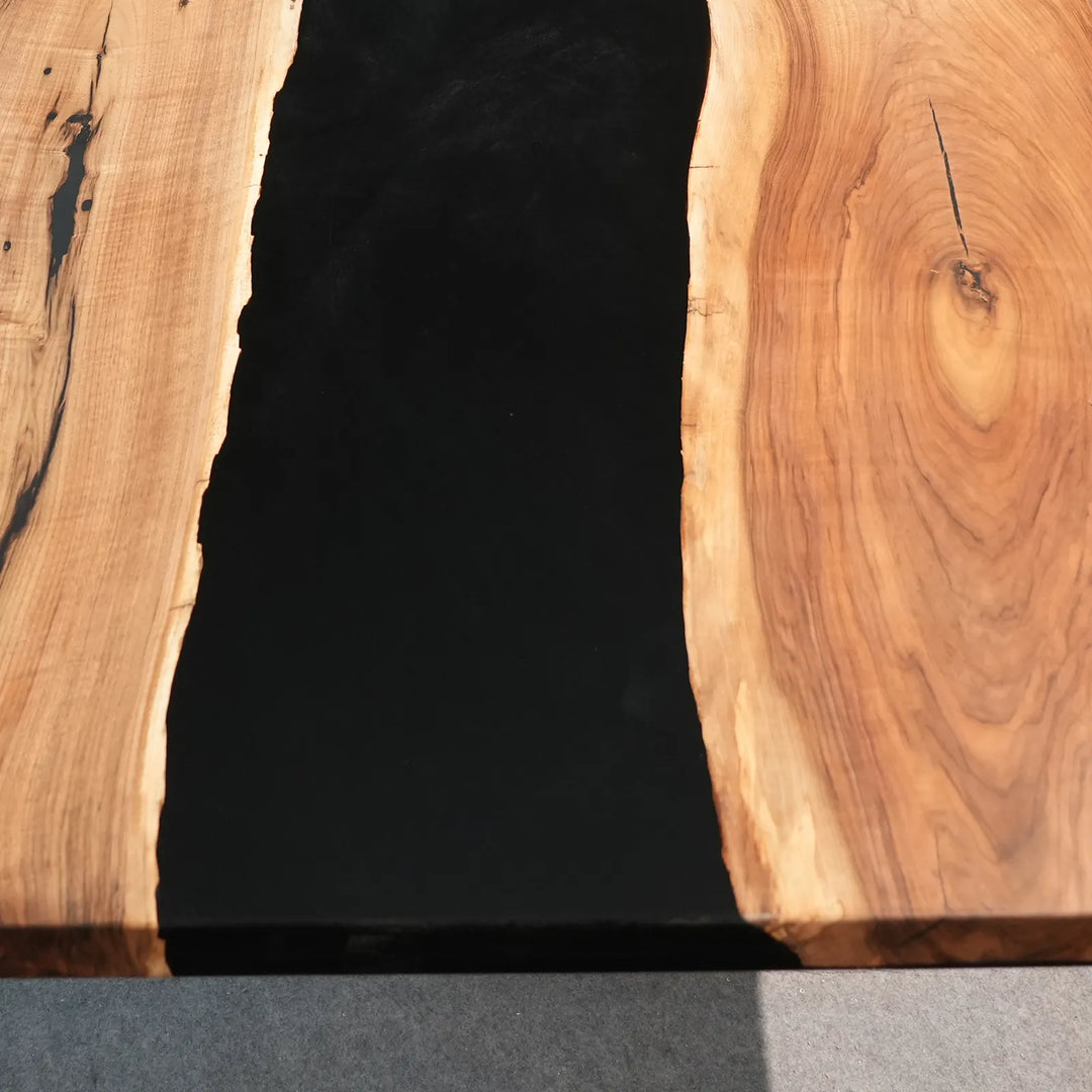 Natural Black Walnut grain beside glossy black epoxy by SeawaveTable