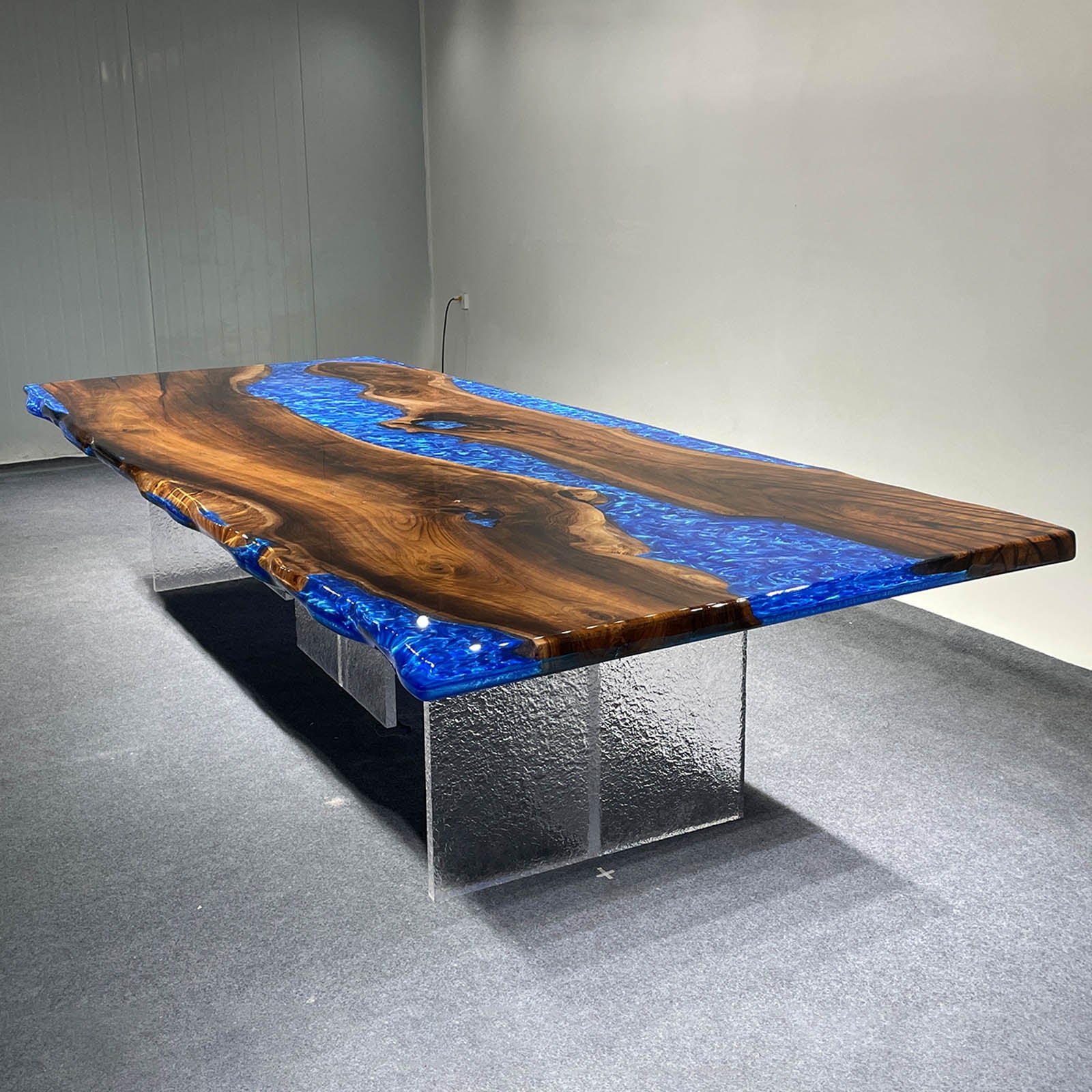 Large handcrafted black walnut banquet table with swirling ocean blue epoxy, luxury event furniture.