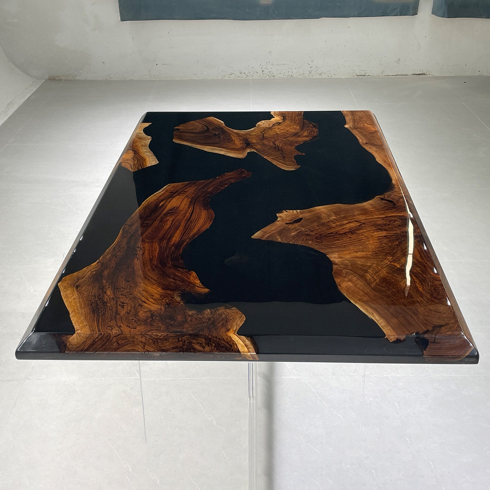 Close-up of black walnut epoxy table surface showing smooth resin finish and wood clarity