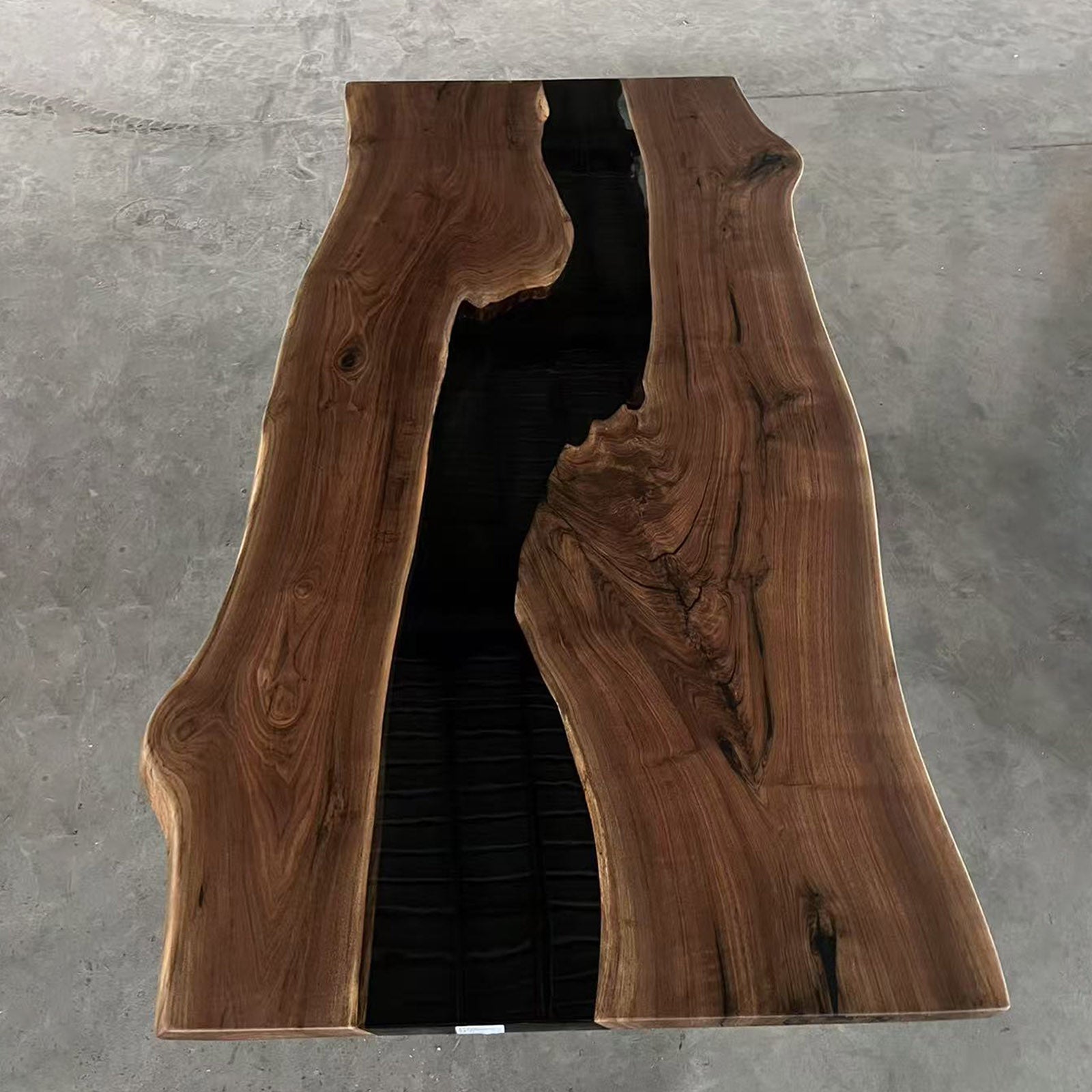 Straight-edge black walnut table with white sapwood accents and sleek black epoxy river, ideal for modern interiors.