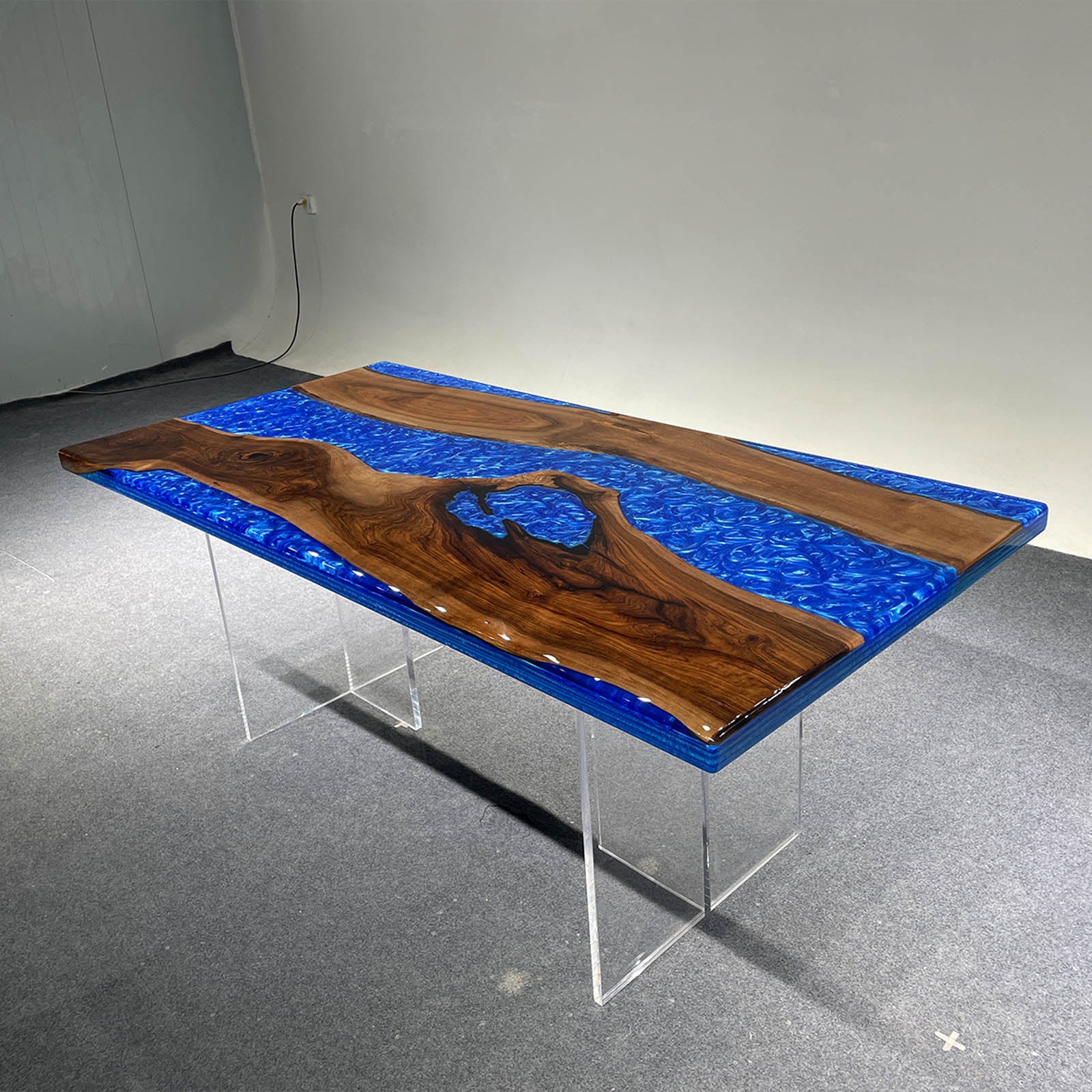 Swirling ocean blue resin river table crafted from solid black walnut, adding elegance to the dining room.