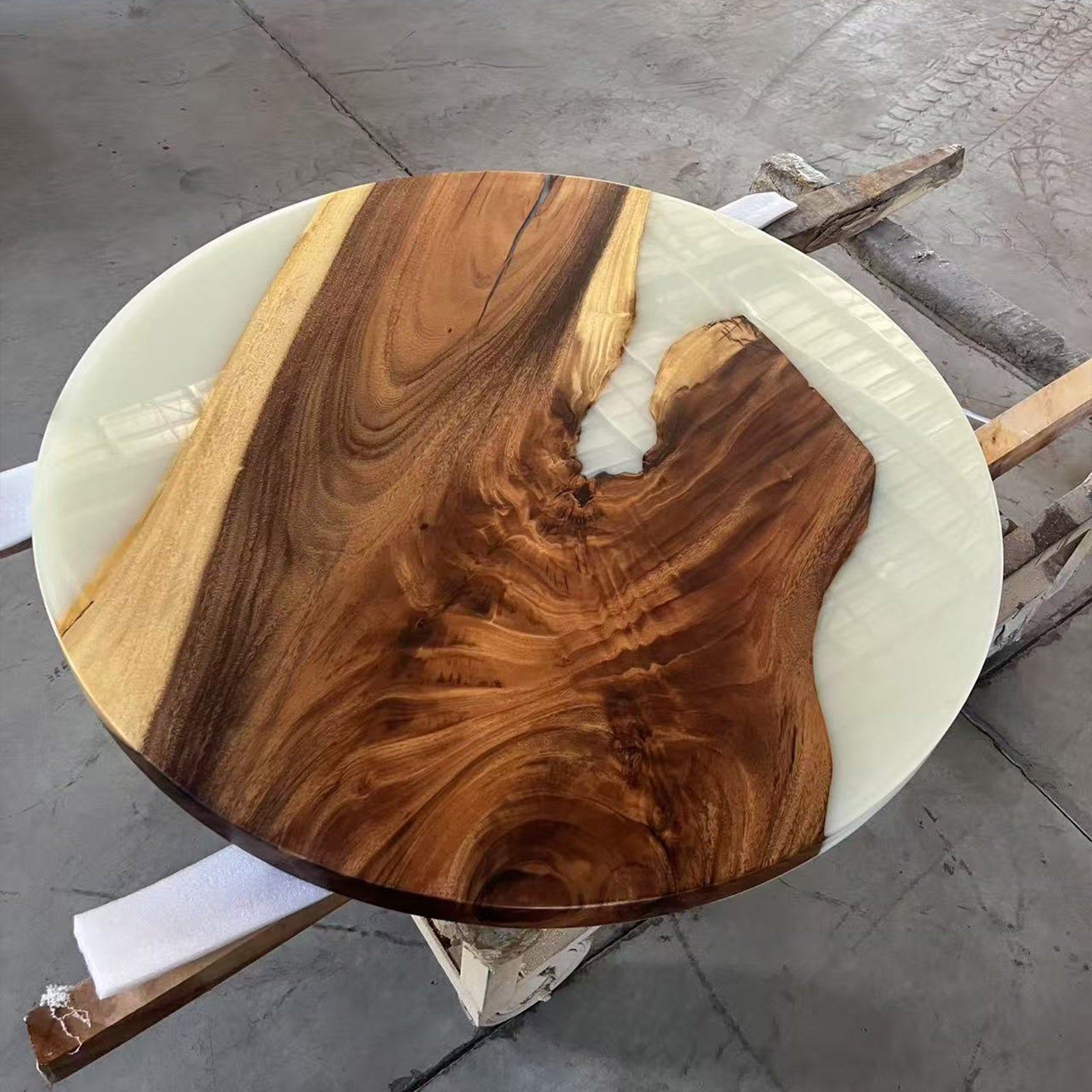 Top view of black walnut table with white epoxy resin, glossy surface finish.