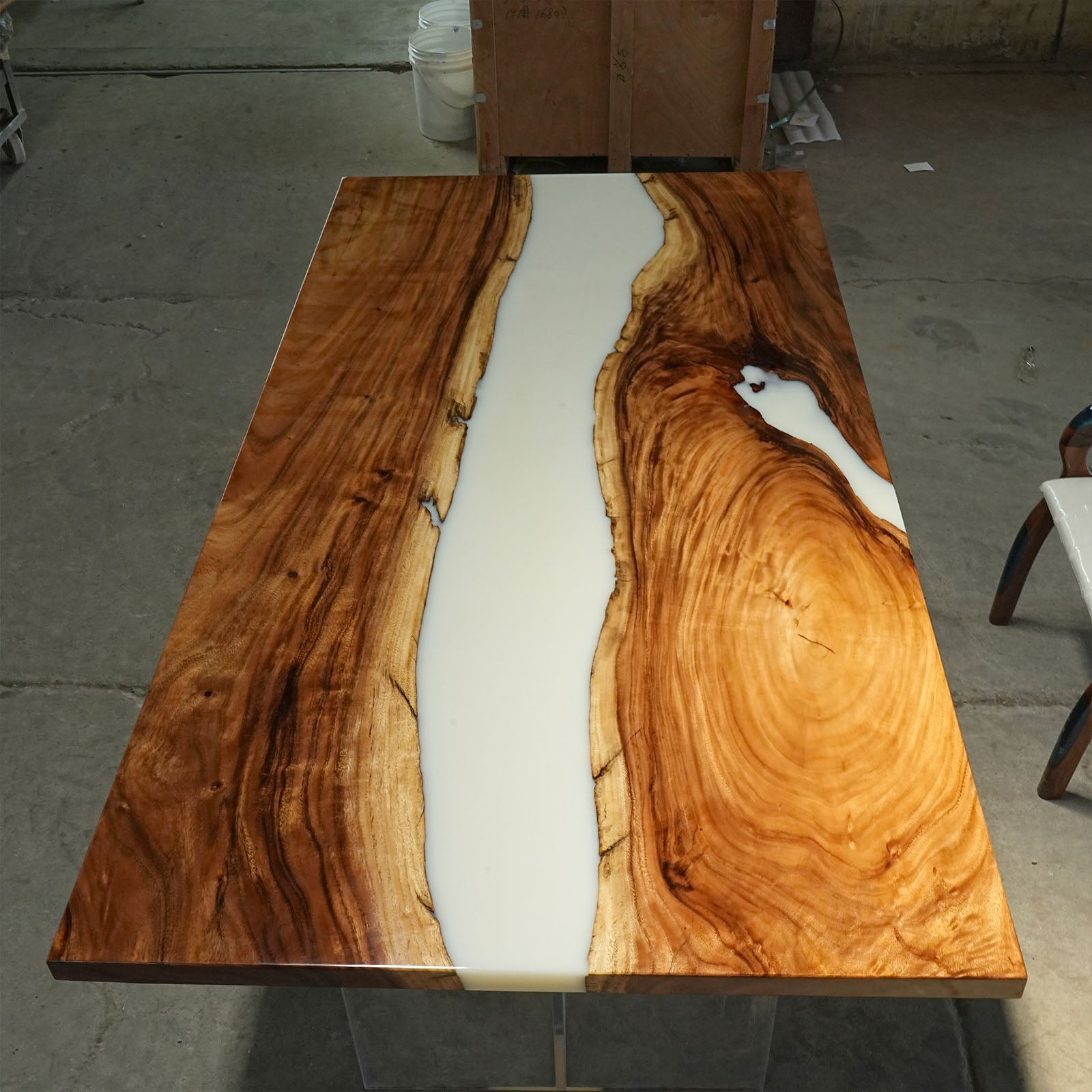 Handcrafted live edge black walnut dining table featuring white resin design.