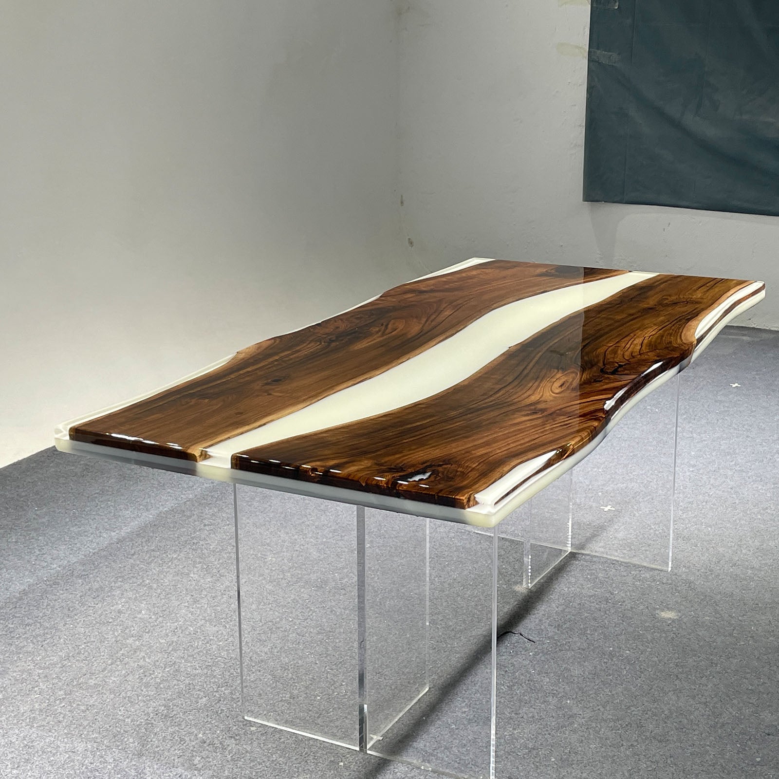 Modern handcrafted black walnut and white resin table suitable for dining or conference spaces.