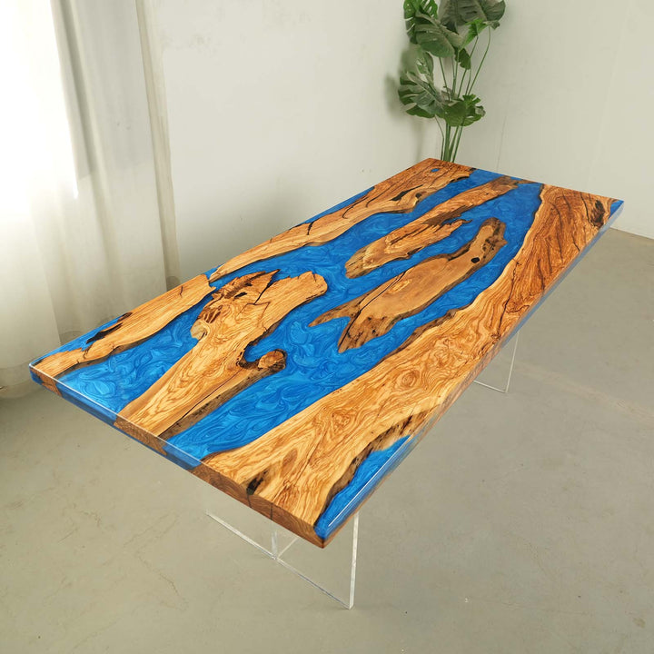 Detailed view of blue epoxy river flowing through solid olive wood tabletop