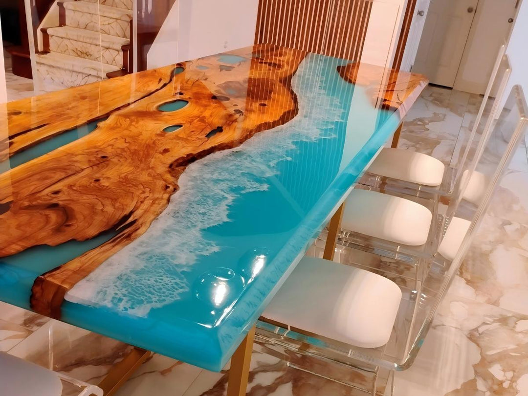 Dining setup featuring clear acrylic chairs and a custom resin table