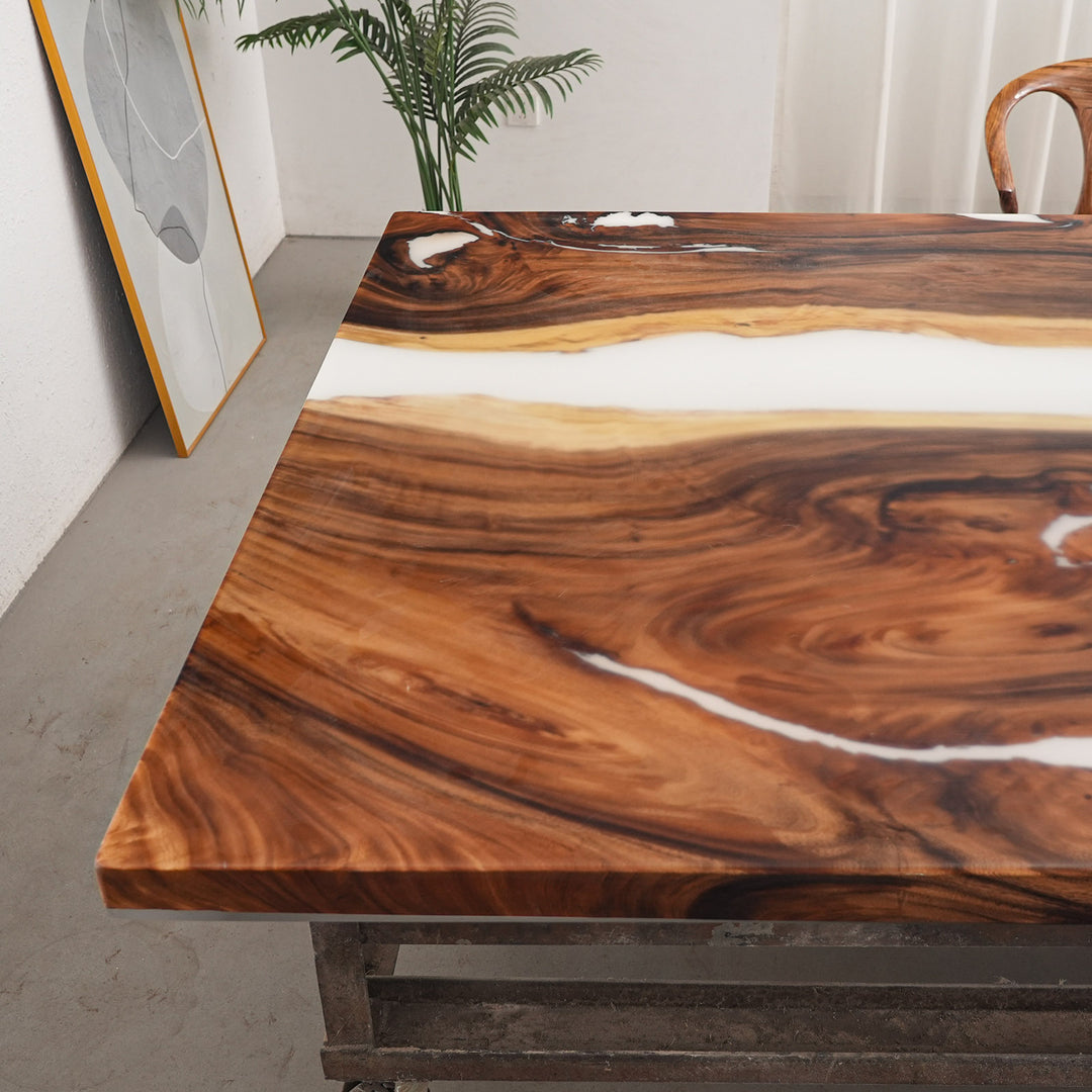 Corner detail of handcrafted walnut white epoxy river table