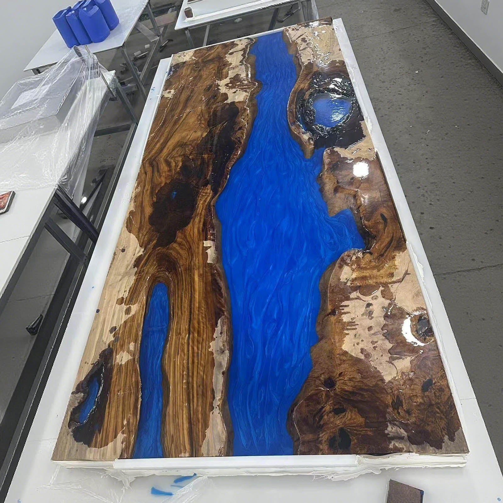 Step 4 – Pouring Swirling Ocean Blue epoxy into the river channel of the CRT-246 table.