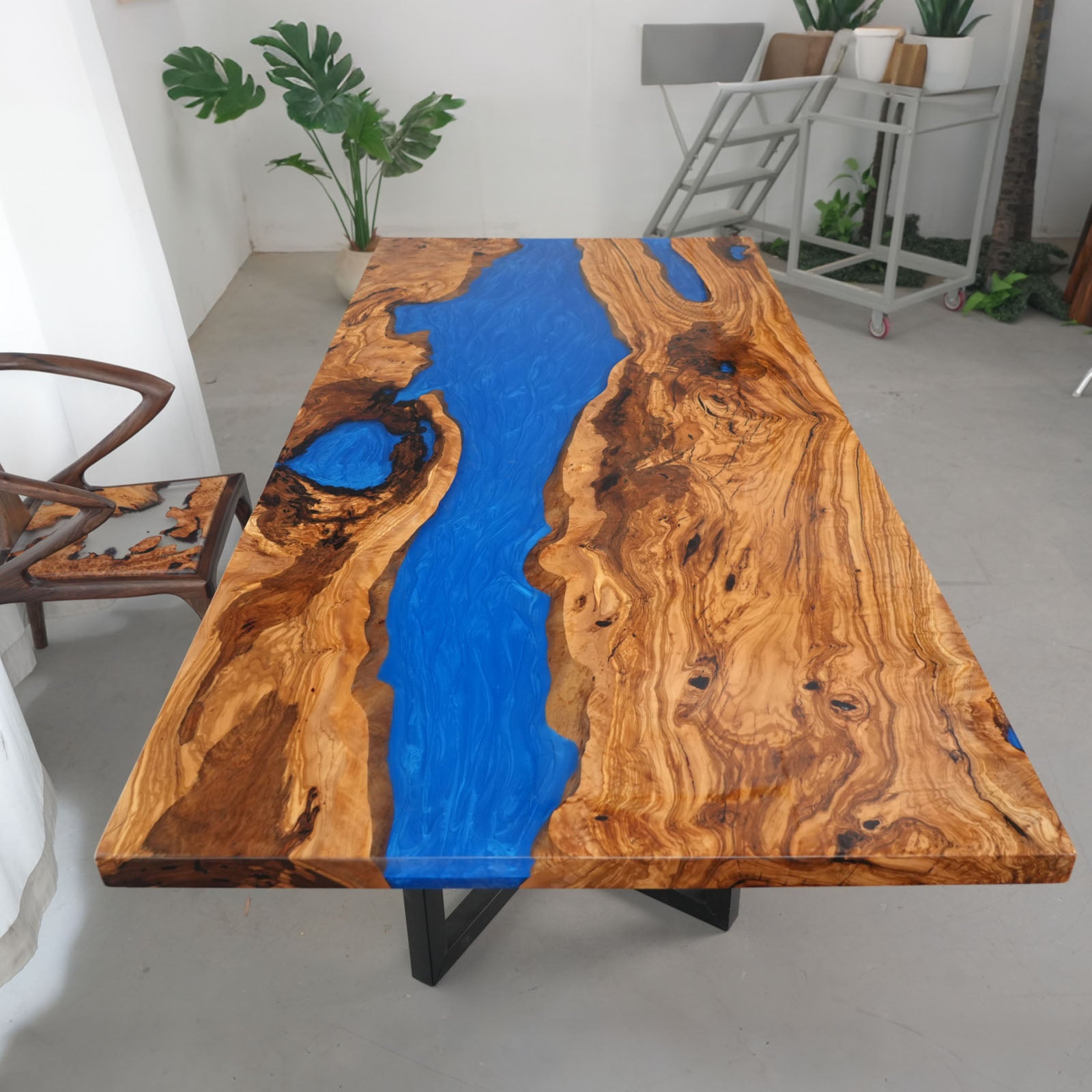 Step 5 – Finished CRT-246 olive wood river table with Swirling Ocean Blue epoxy and matte–gloss finish.