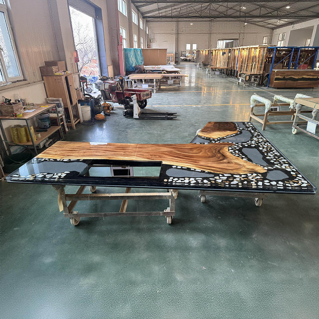 Close-up of black resin river flowing through solid walnut kitchen countertop