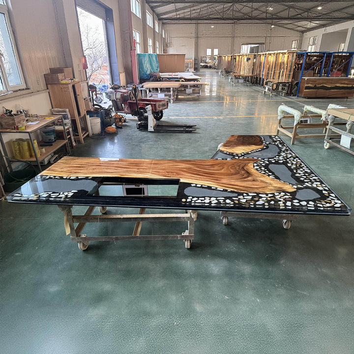 Close-up of black resin river flowing through solid walnut kitchen countertop