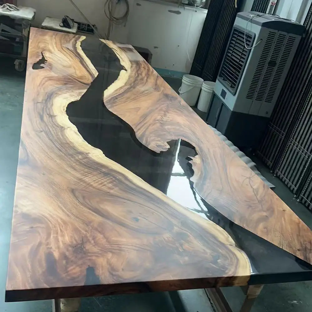 Pouring translucent black epoxy resin between walnut slabs for the CRT-295 river table