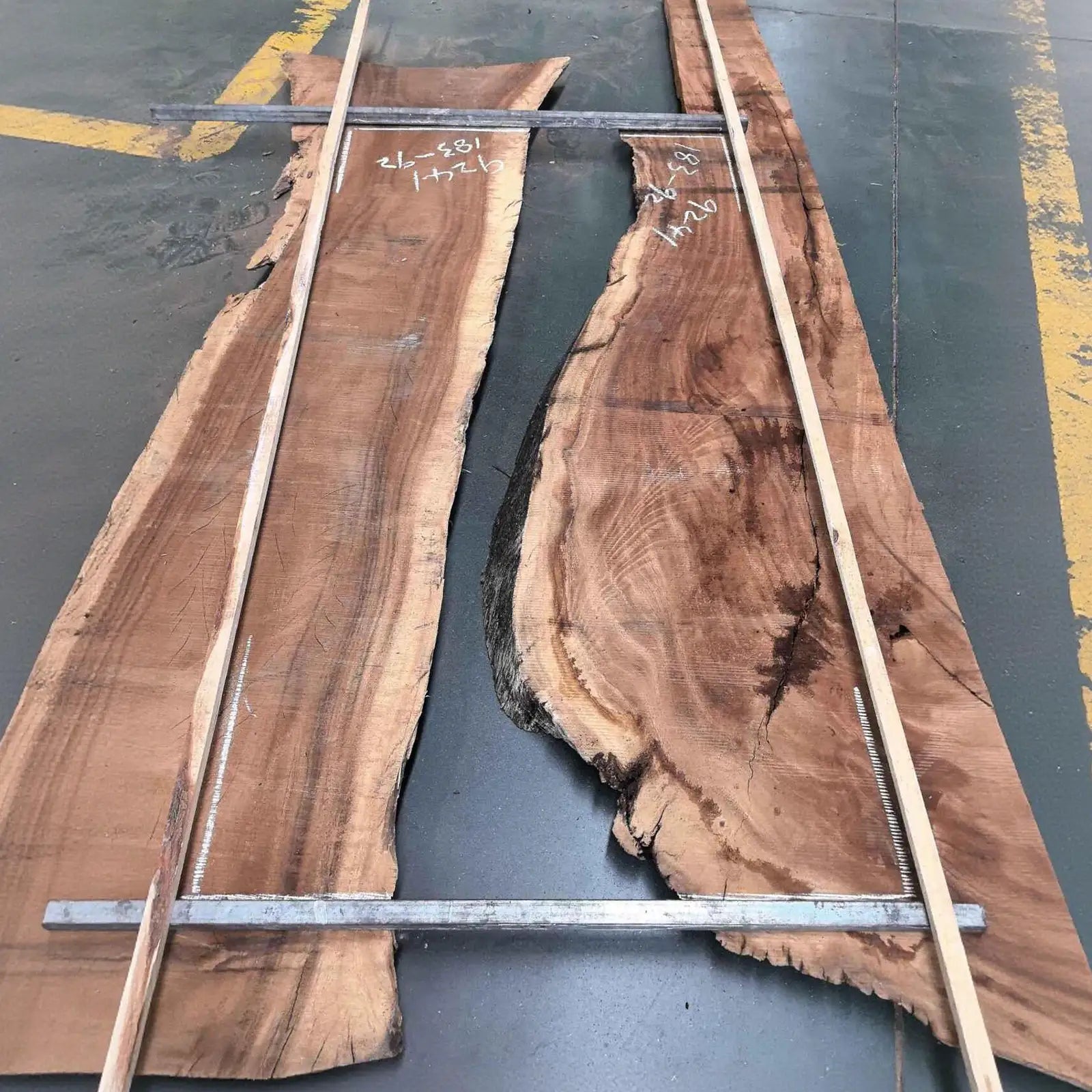 custom walnut slabs with visible grain patterns on a dark surface.