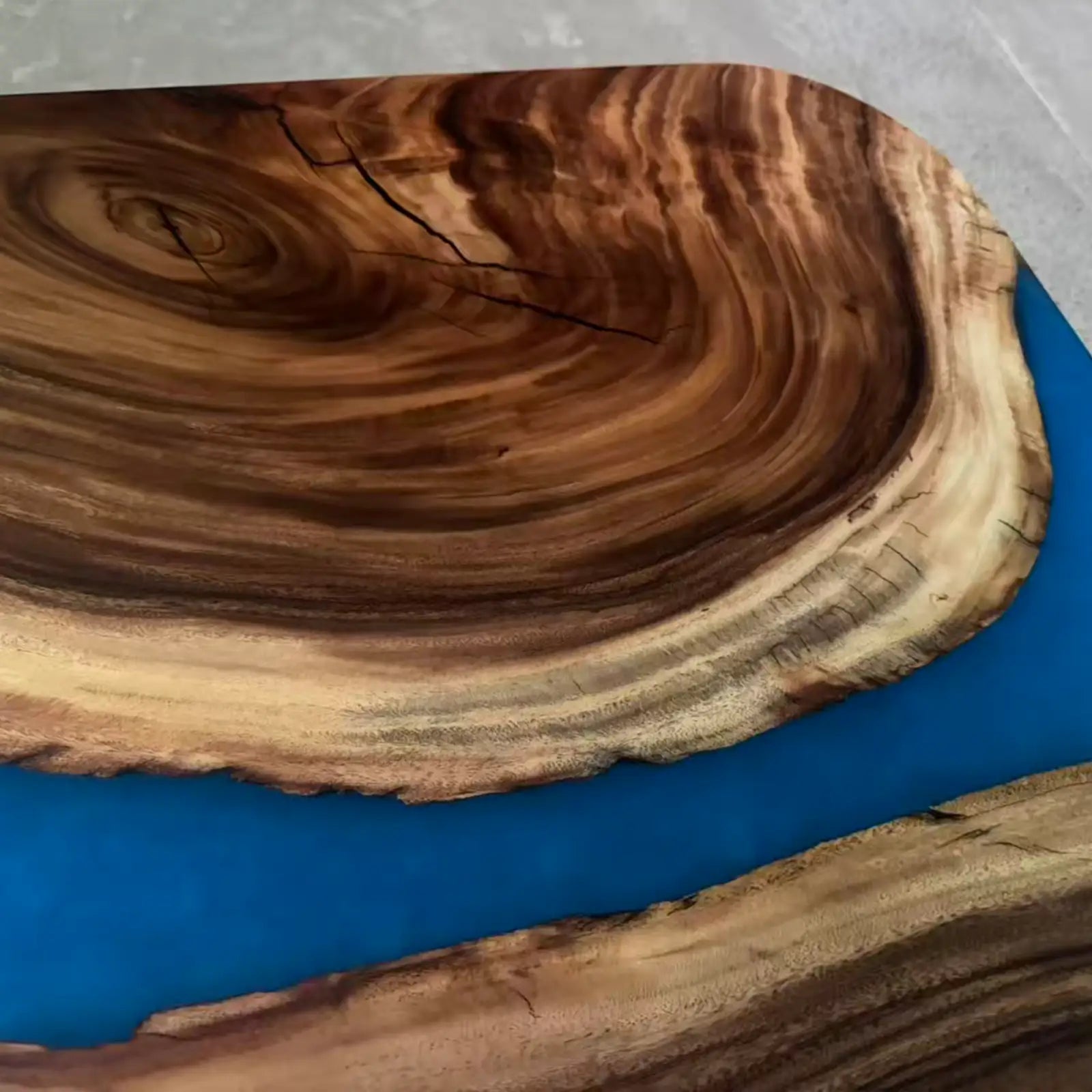 Close up of walnut blue resin river dining table