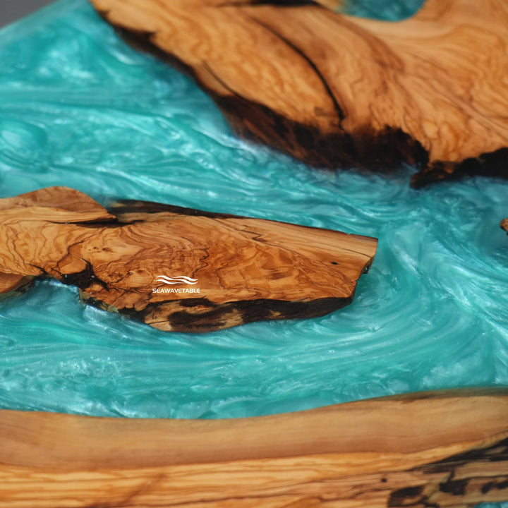 Custom olive wood epoxy river table from multiple angles highlighting beveled edge and craftsmanship