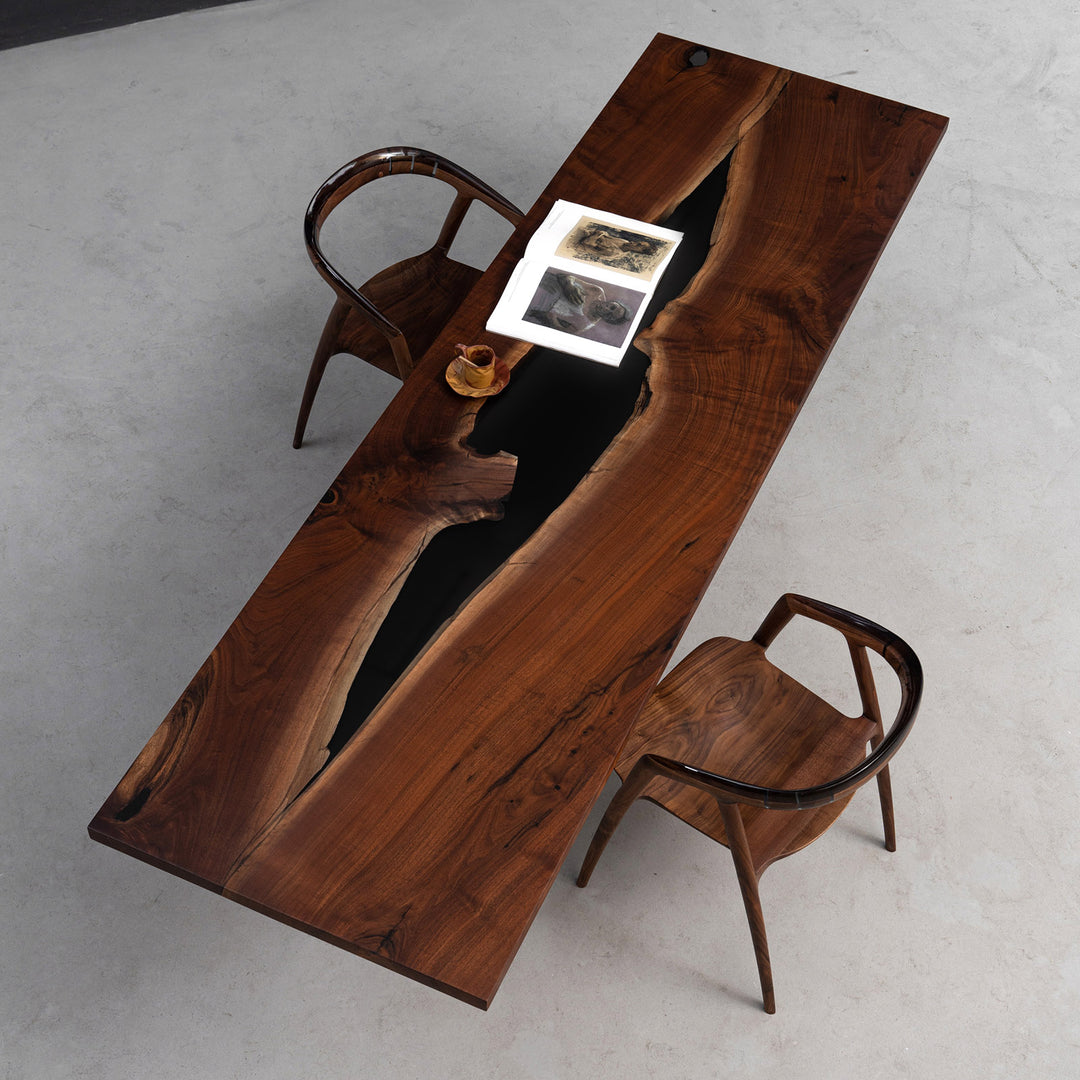 Close-up of transparent and opaque black resin pattern on luxury walnut conference table