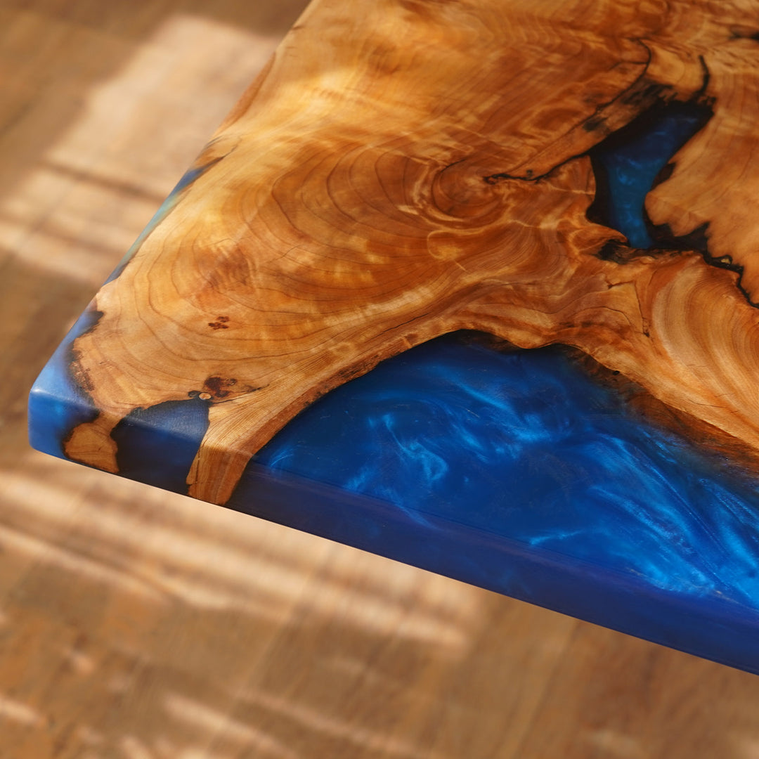 Wooden surface with blue resin inlay on a wooden background