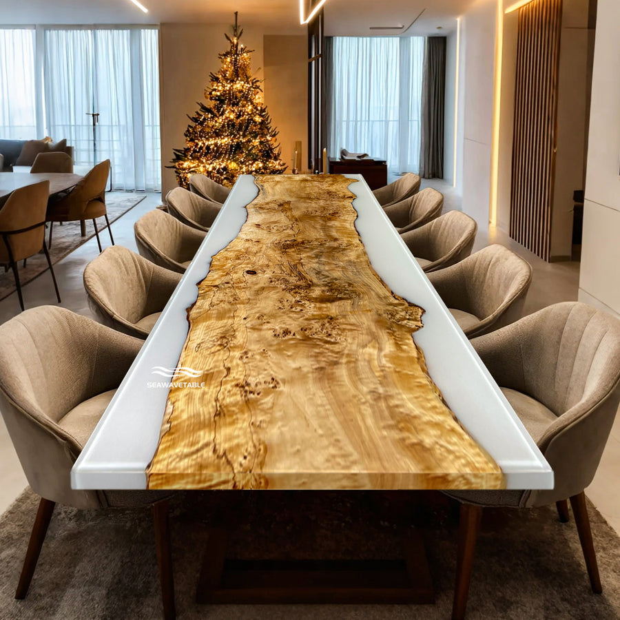 Dining room with a long wooden table and chairs, decorated for Christmas.