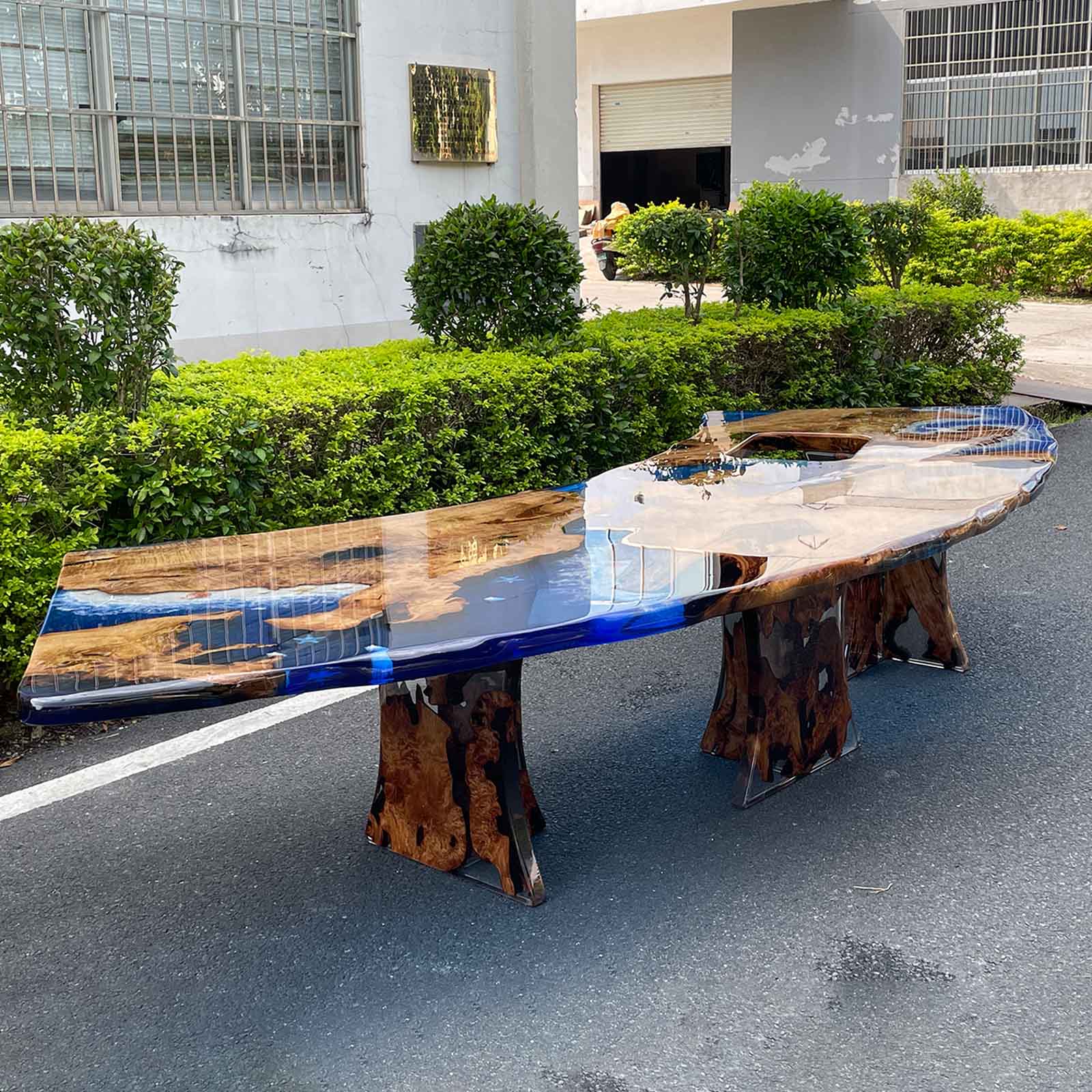 Golden camphor bar-height resin table with live edge design and ocean-blue epoxy river.