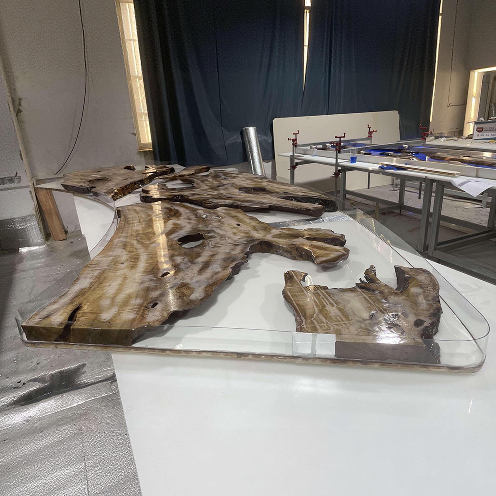 Close-up of live edge golden camphor wood and ocean-blue resin river, highlighting natural textures and craftsmanship.