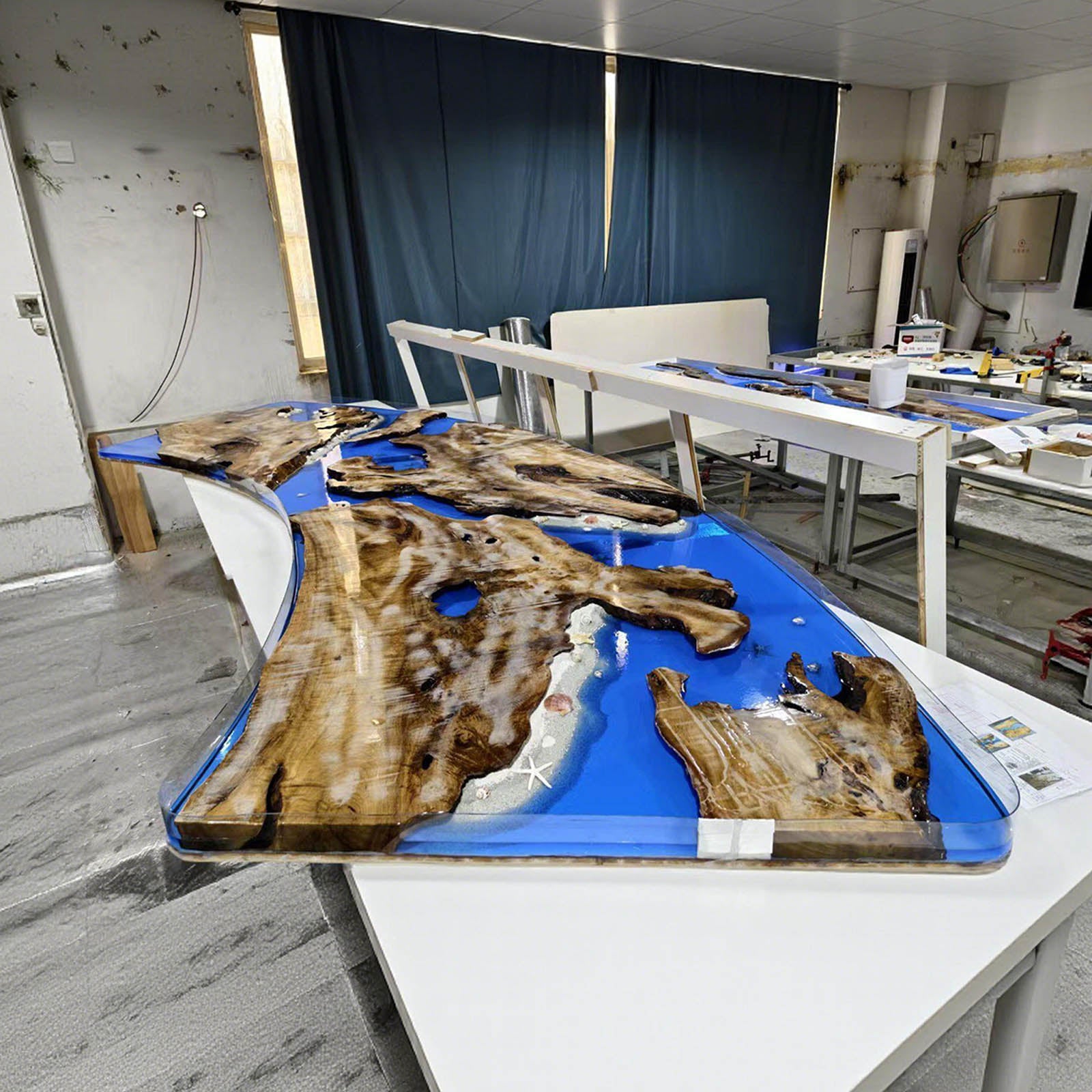 Side view of golden camphor live edge resin table showing flowing epoxy river and solid wood construction.