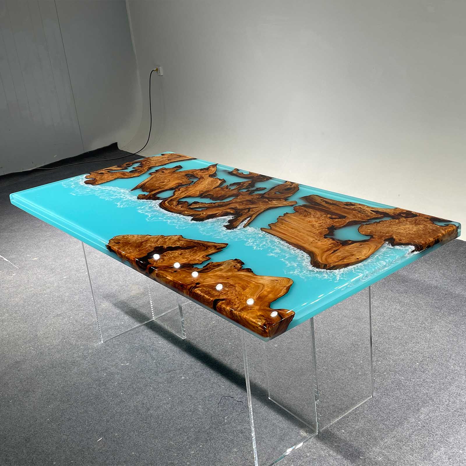 Glossy finish golden camphor dining table with swirling blue and white ocean epoxy.