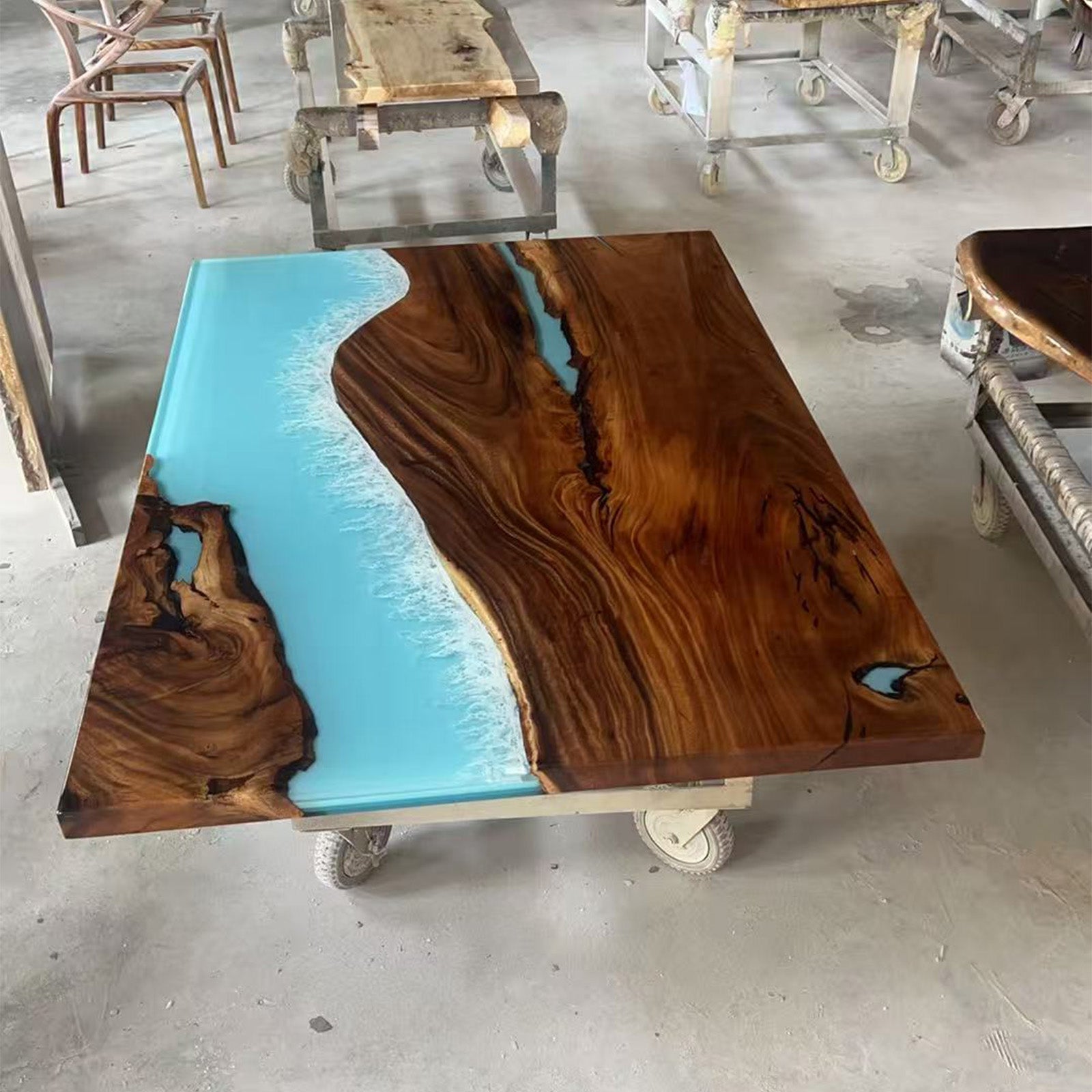 Large handcrafted banquet table made of golden camphor wood with ocean blue epoxy design.