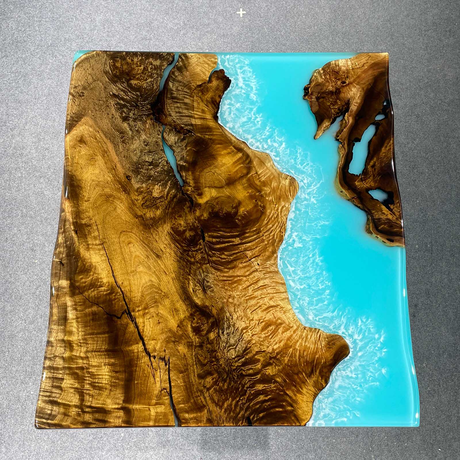 Handcrafted Ocean Serenity console table with golden camphor wood and wave epoxy resin.