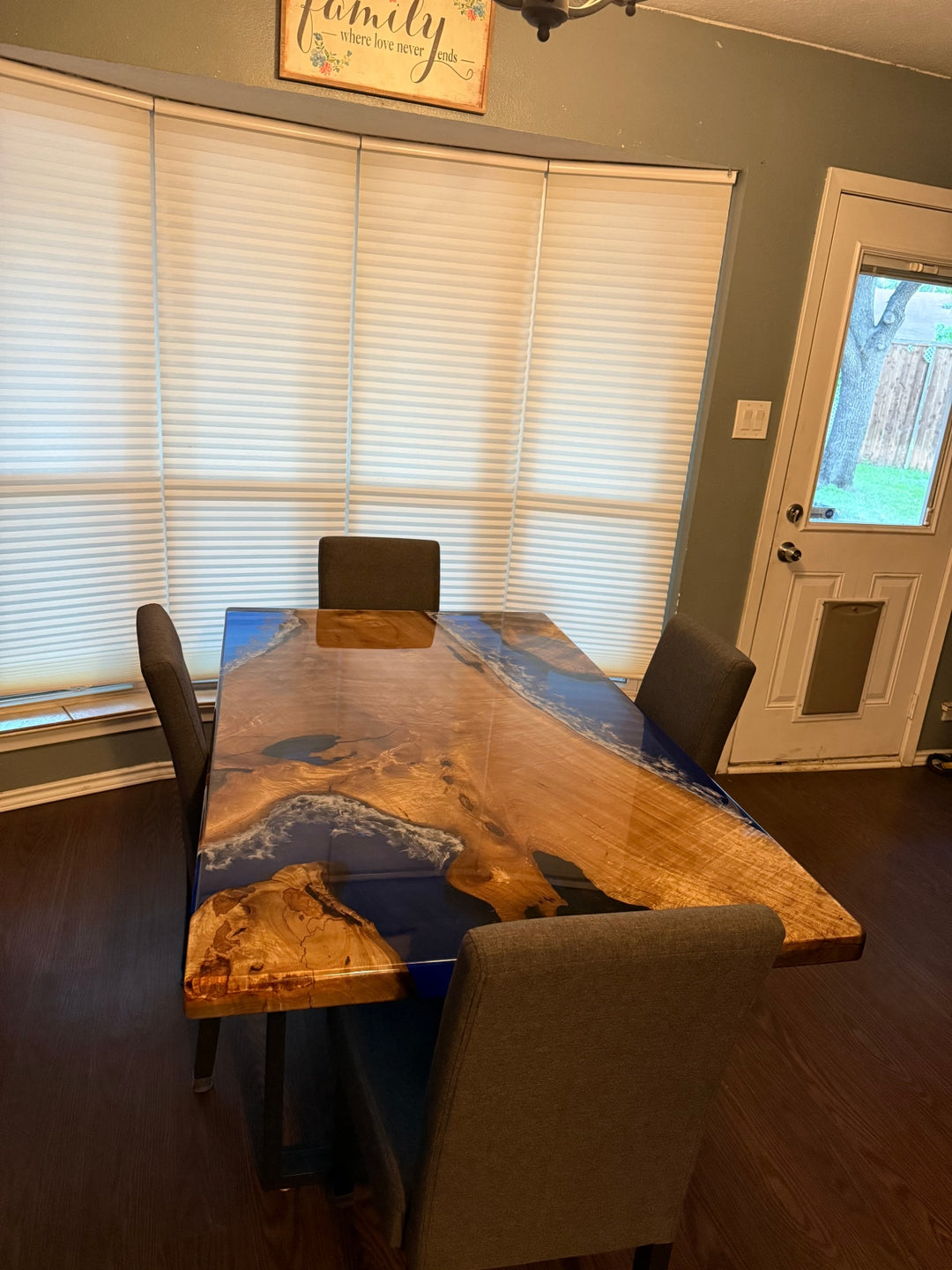 Straight-edge detail of a golden camphor epoxy table, featuring transparent blue resin and a sleek high-gloss finish for a modern coastal look.