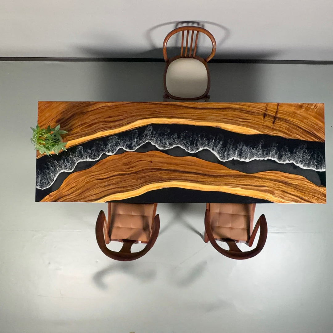 Detail of walnut table featuring black resin river with white wave effects