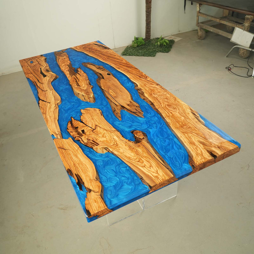 Mirror-like high-gloss epoxy finish reflecting light on custom olive wood dining table